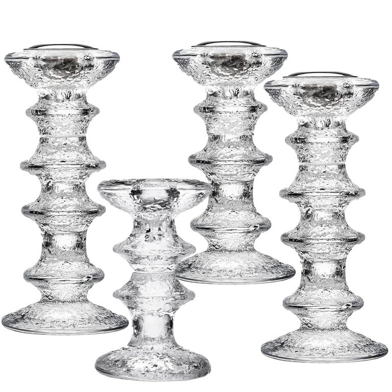 Textured clear molded glass. Composed as a column with projecting bands, a flared mouth and a round base. Designed by Sarpaneva for Liitala, Finland.

The tallest, four-ring candleholder is 7.25 in. H, the three-ring design is 5.75 in. H, and the