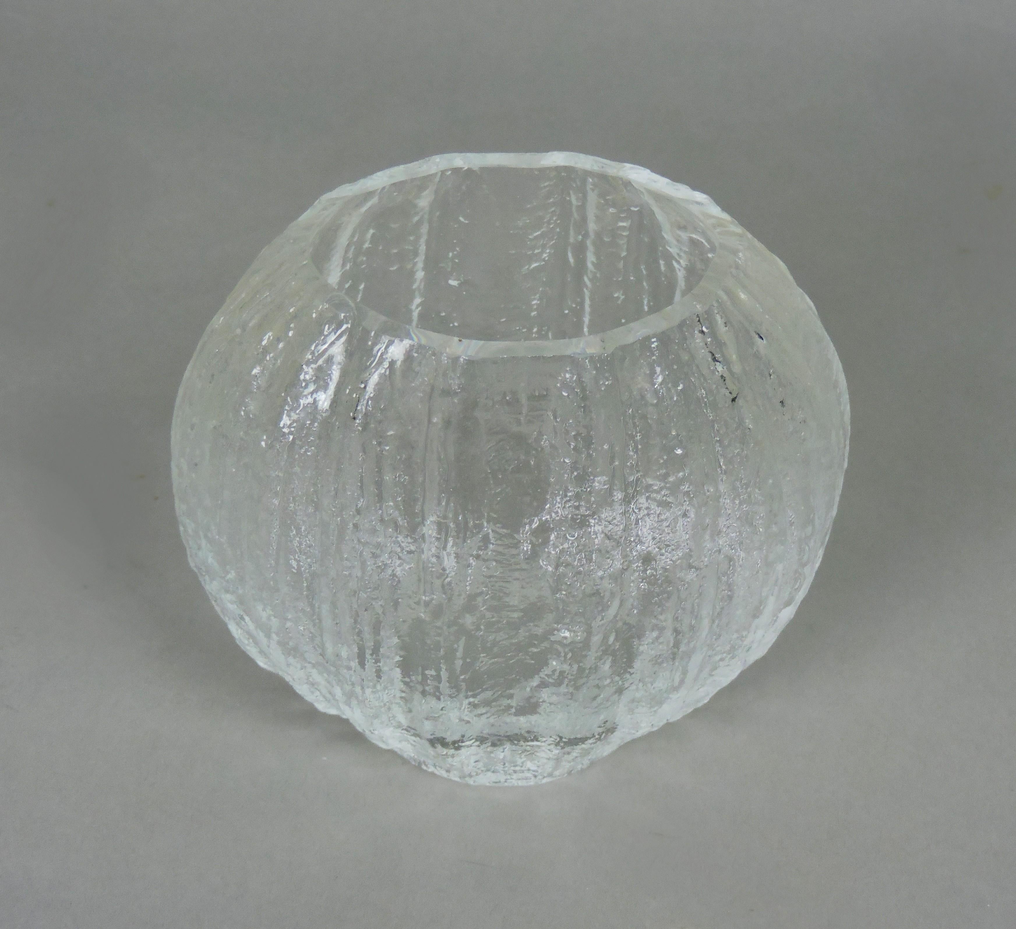 Beautiful glass Minora vase designed by Timo Sarpaneva and manufactured in Finland by Iitala. This vase has an icy texured finish with a polished rim. Engraved TS on the bottom.

About the designer:
Timo Tapani Sarpaneva (31 October 1926 – 6 October