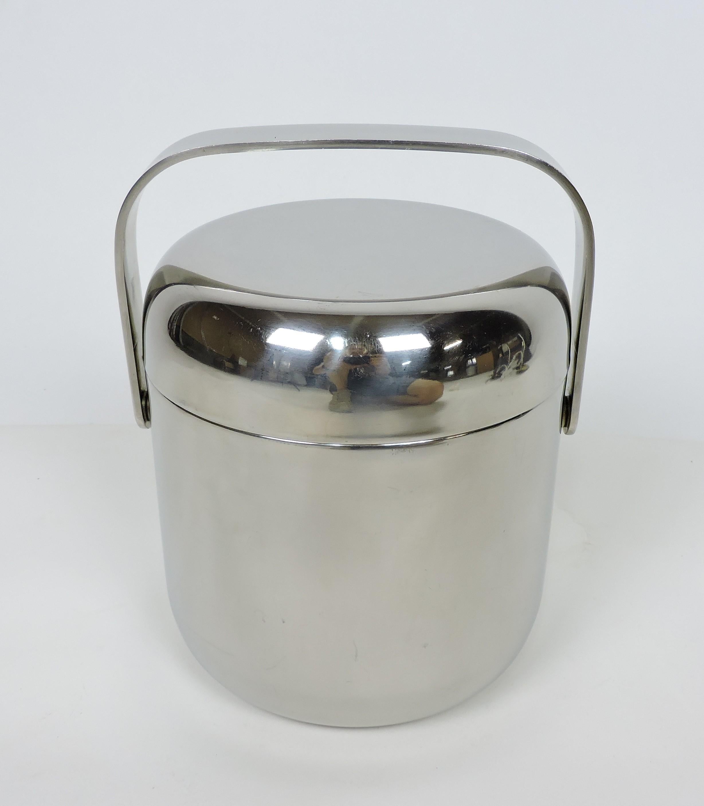 Beautiful and stylish double walled polished stainless steel ice bucket designed by Timo Sarpaneva and made in Finland by OPA Ltd. Designed in 1970, this ice bucket has a minimalist gently curved shape with a pivoting handle and is made of 18-8