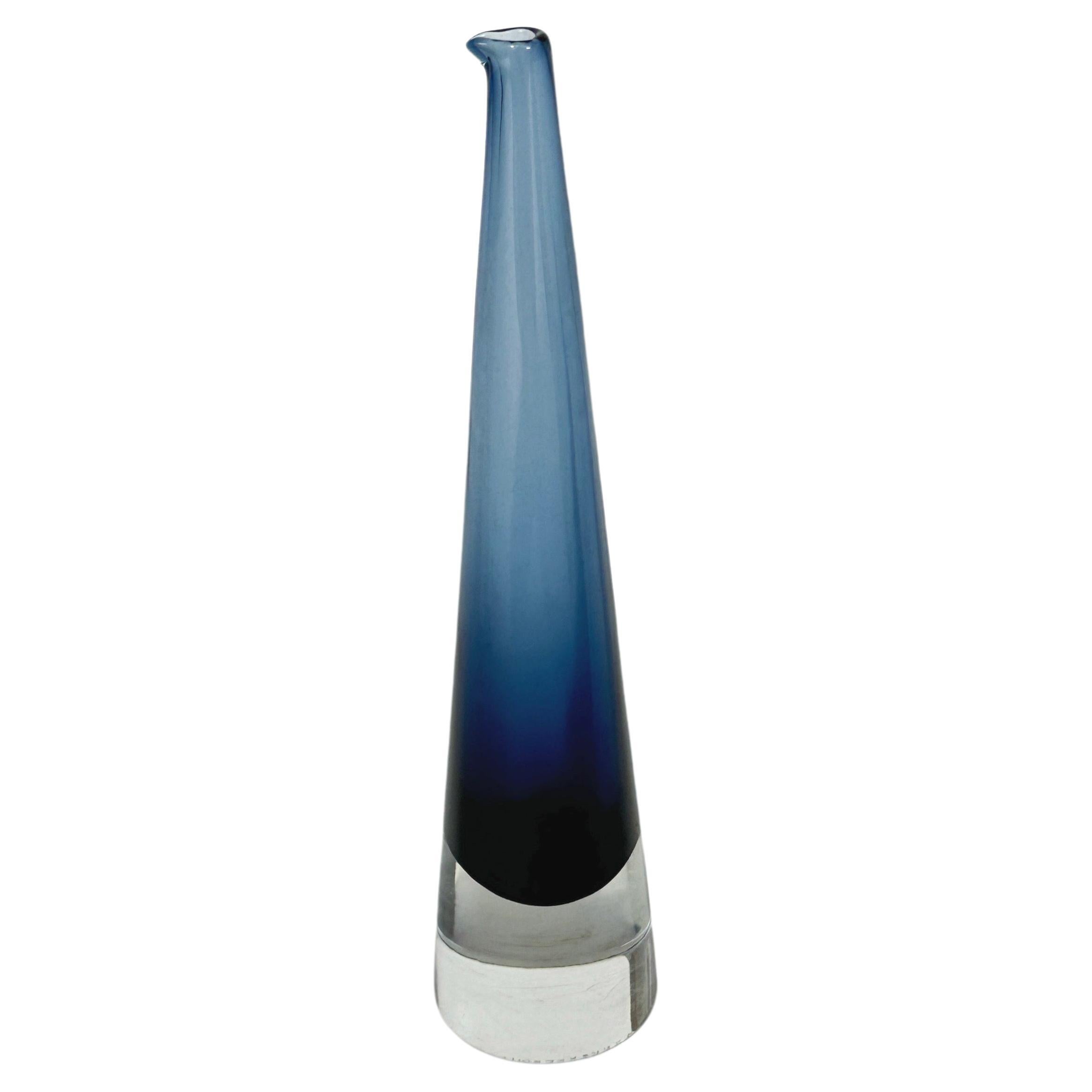 Timo Sarpaneva decanter vase ‚Jääpuikko‘ (icicle) in deep blue crytsal for Iittala, made in Finland in 1958.

Good condition with some scratches and minor water (lime) staining on the inside of the neck.

Signed underneath with the artists name and