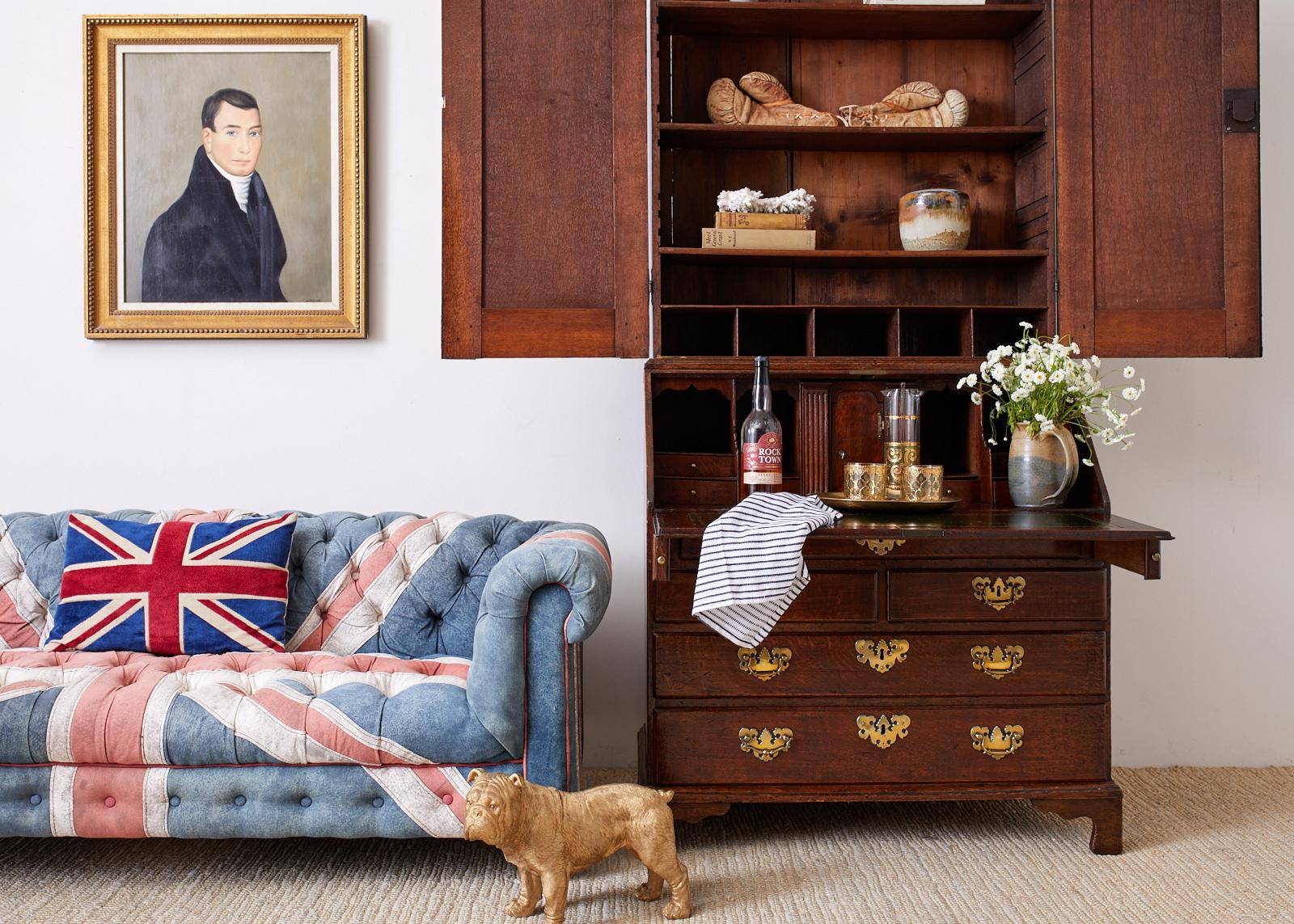Fabulous tufted chesterfield settee designed by Timothy Oulton. Features a cotton denim fabric upholstery pieced together in a union jack pattern design. Beautifully faded and aged patina with excellent joinery and craftsmanship. Made with a low 25