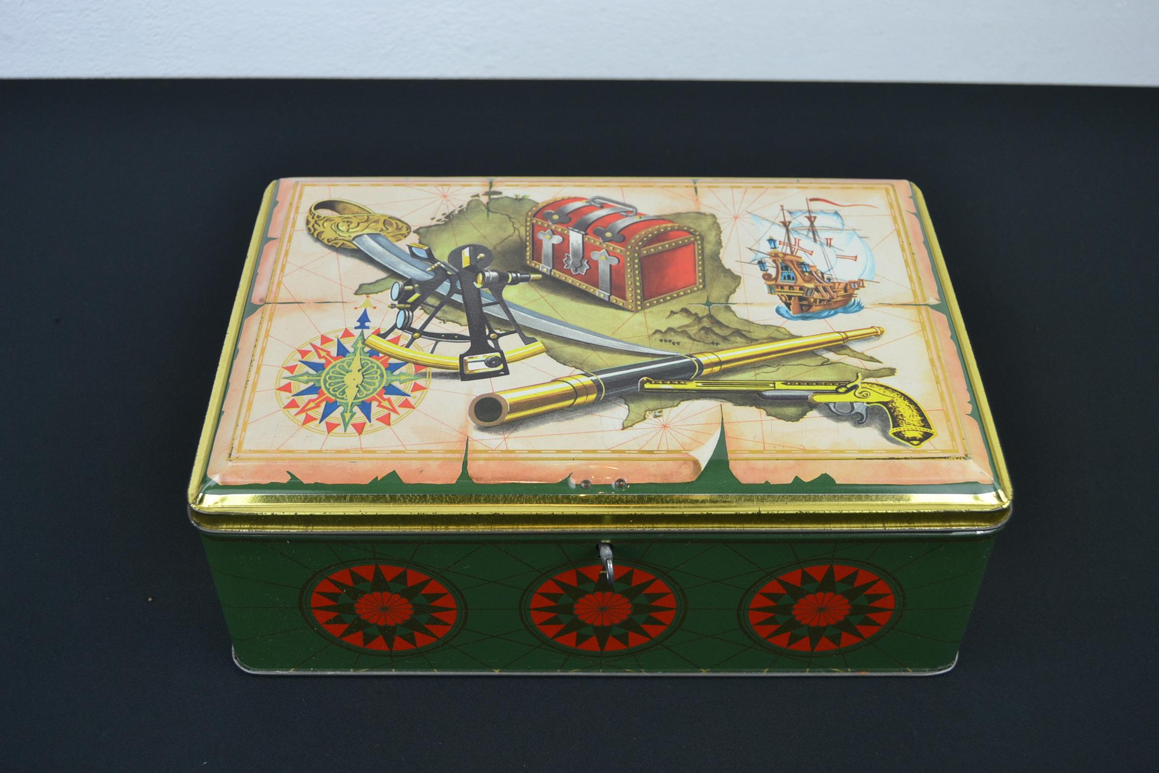 Vintage biscuit tin theme Pirate - Piracy.
This 1950s tin box is a great decorative box or storage box with beautiful design of the material of the sea rover:
pirate ship, a map, compass, binoculars or telescope, pistol, sword, location of the