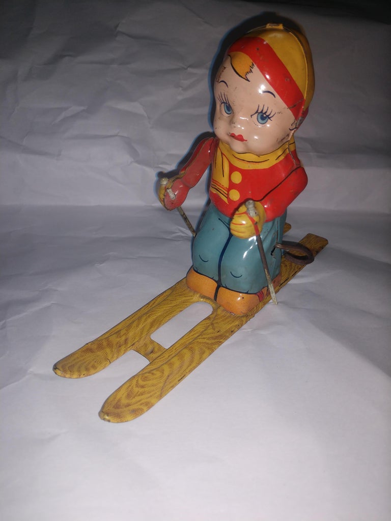 Fabulous working tin Litho toy skier by the Chein toy co. C1945. In excellent vintage condition with minimal wear.