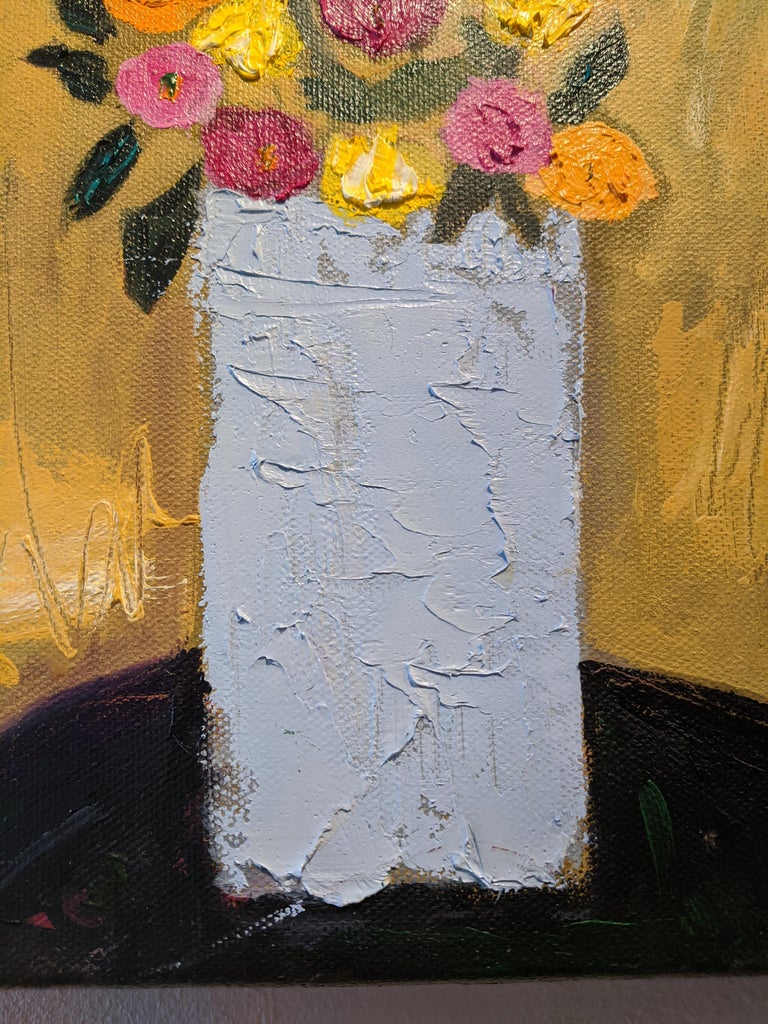 This oil on canvas painting is a lovely still-life. In the center of the painting is a light blue vase with a bouquet of magenta, ochre, and yellow flowers, all with dark leaves. The vase sits on a dark tablecloth; The background, with wide strokes,