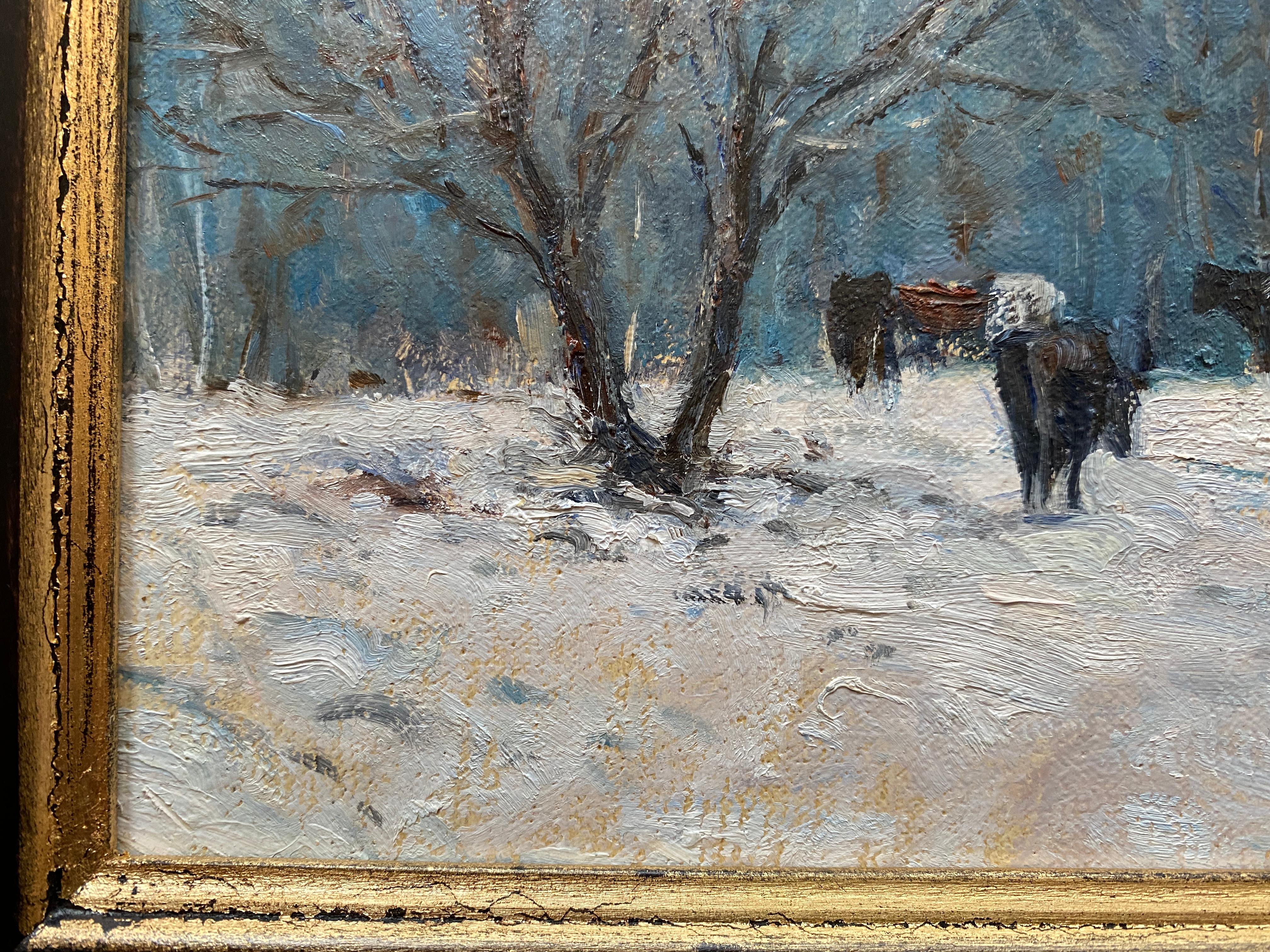 Painted en plein air in Vermont. An oil painting of a group of cows, grazing in the snow in Vermont. An impressionistic view of trees makes a brushy backdrop in blues, greens, and purples. A few bare branched trees flank the composition. Tire tracks
