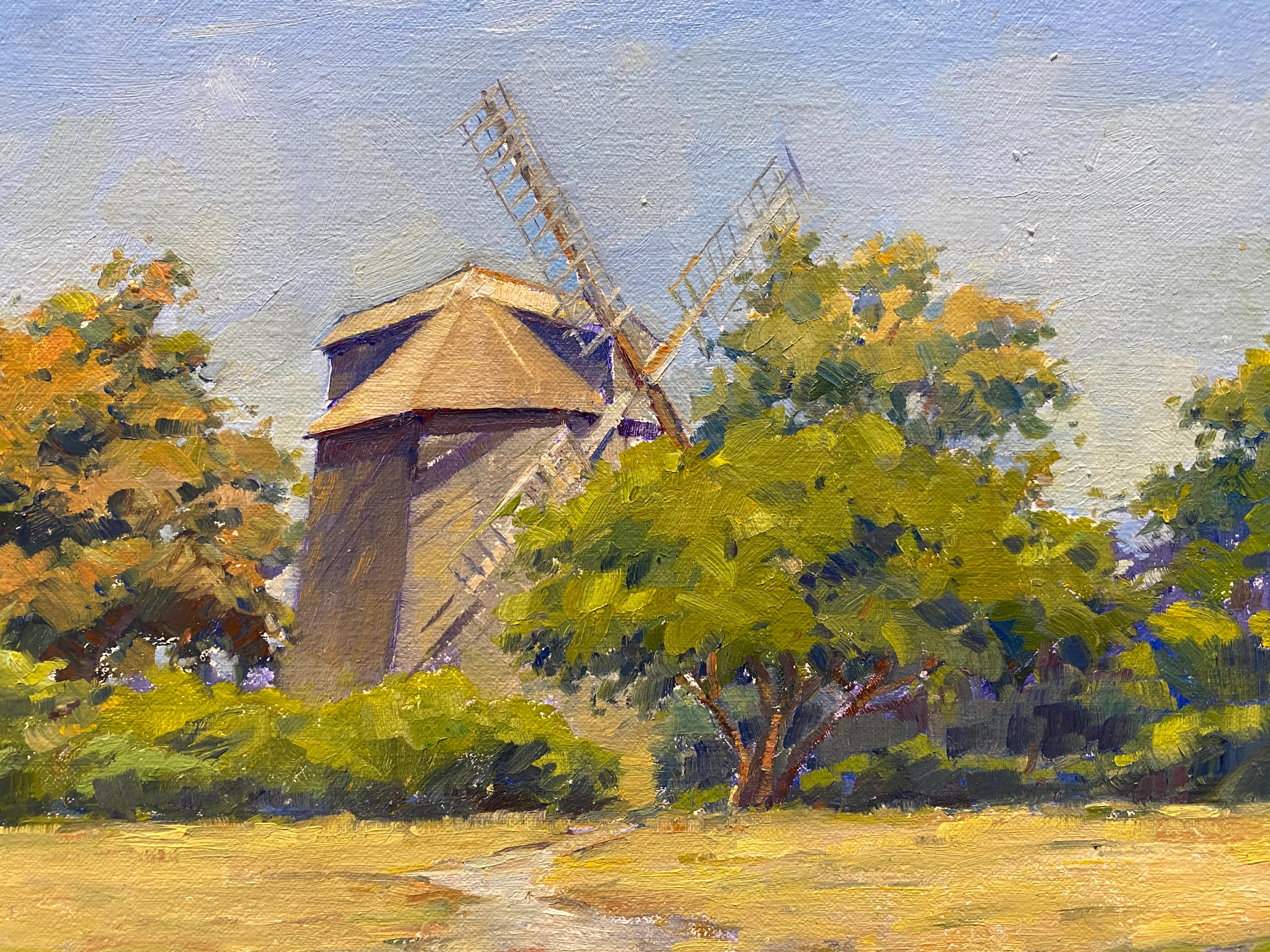 Orsolic Dalessio depicts the iconic landmark of Sag Harbor: its windmill. The plein air painting shows no sign of the bustling town behind. The windmill is cloistered within the puffy impressionistic trees as it faces out onto the blue harbor.