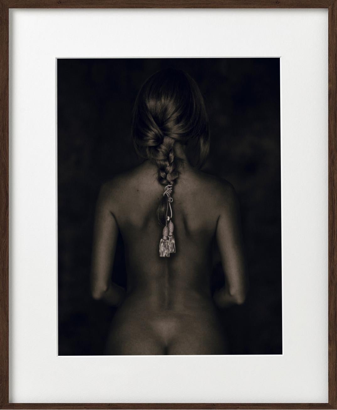 Nu de Dos - female nude from behind with cord in braided hari sitting - Photograph by Tina Trumpp