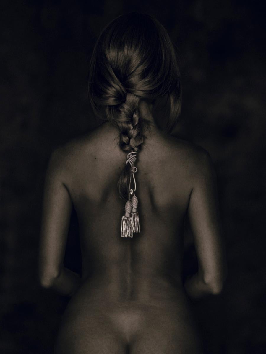 Tina Trumpp Color Photograph - Nu de Dos - female nude from behind with cord in braided hari sitting
