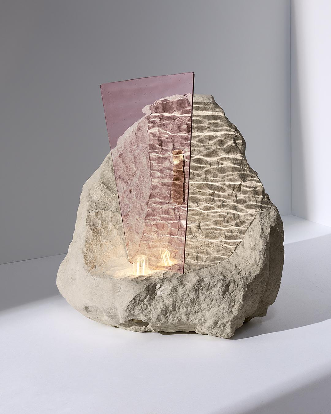 Tinharé by Precious Artefact
Dimensions: Base: Width 15.74 inches, height 16.53 inches, depth 13.77 inches
 Glass height 11.81 inches 
 Total height 18.50 inches
Materials: Translucent wavy rose glass, Tufa stone and brass finishes

Off the