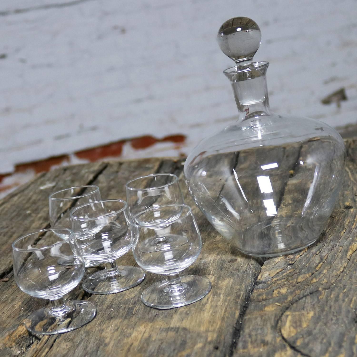 Handsome clear crystal Tinka decanter set with decanter and five glasses designed by A. D. Copier for Royal Leerdam Holland. The decanter and five glasses are all in fabulous vintage condition with no chips, cracks, or chiggers. This set comes with