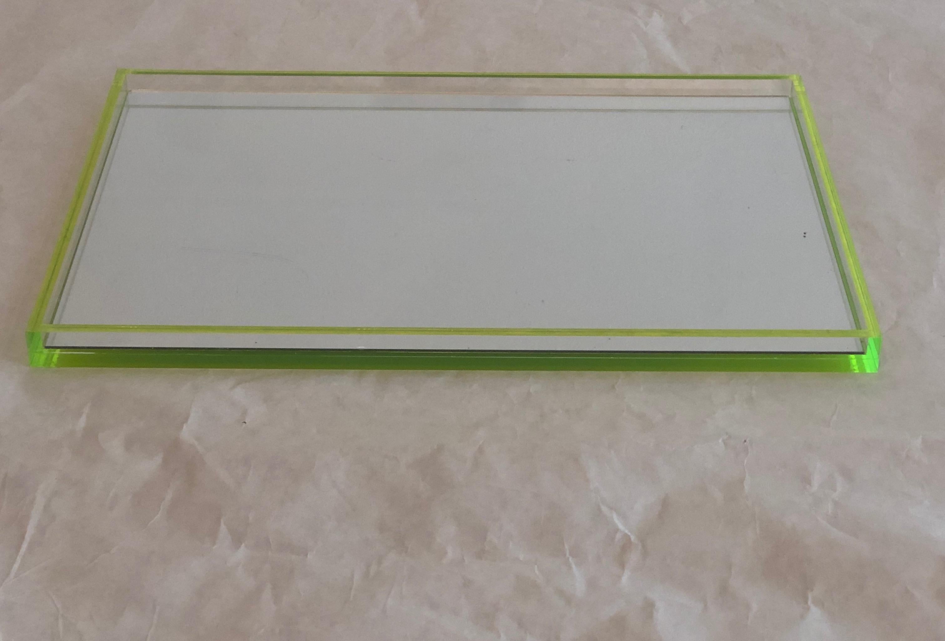 Offered is an early 2000 signed Tinsley Mortimer clear Lucite with neon lime green accents and mirror base cocktail ware / drinks’ tray. This tray has so many other possible uses as well. The neon lime green accents are so on trend. The Lucite used