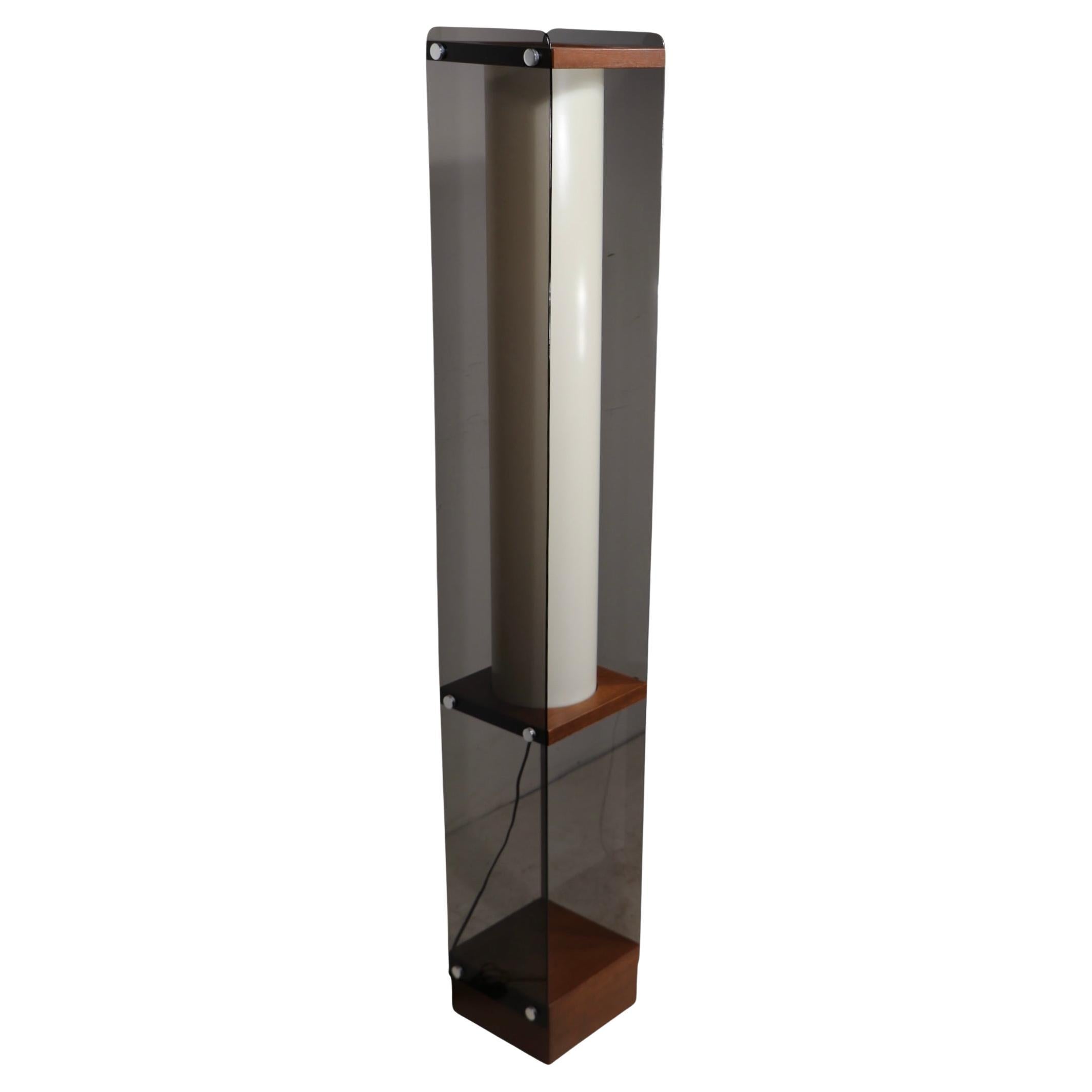 Exceptional mid century, post modern tótem form floor lamp, designed by Adrian Pearsall, for the Modeline Lamp Company, circa 1960/70’s. The lamp features a wood base, tinted translucent lucite sides, a white plastic  tubular interior diffuser