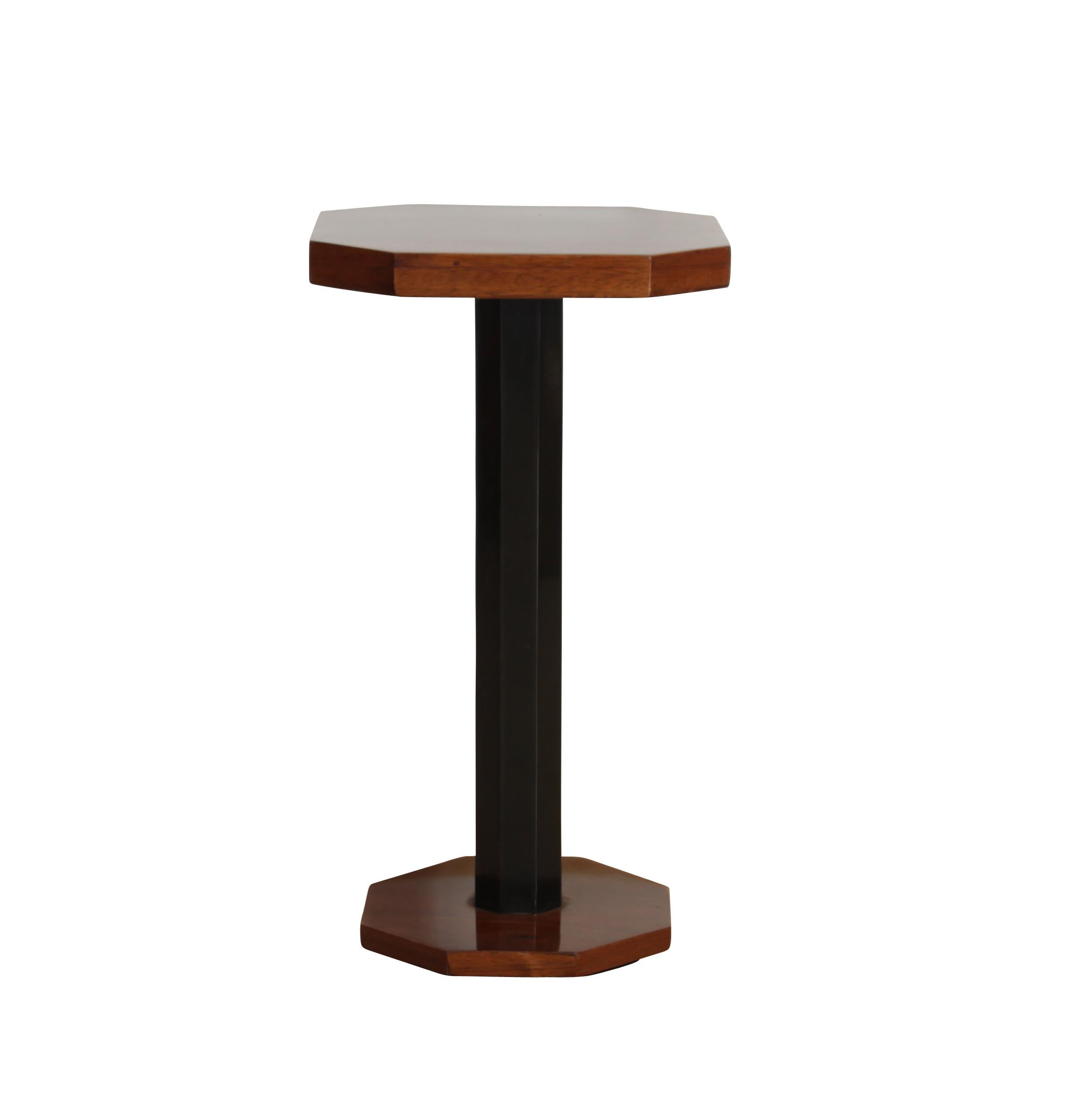 Tiny classic Art Deco table, meant to be placed next to a club chair or sofa. 
It has an octagonal shape at the top, middle and bottom. Top and bottom is walnut veneer, the middle part is ebonized and polished walnut. The table has been