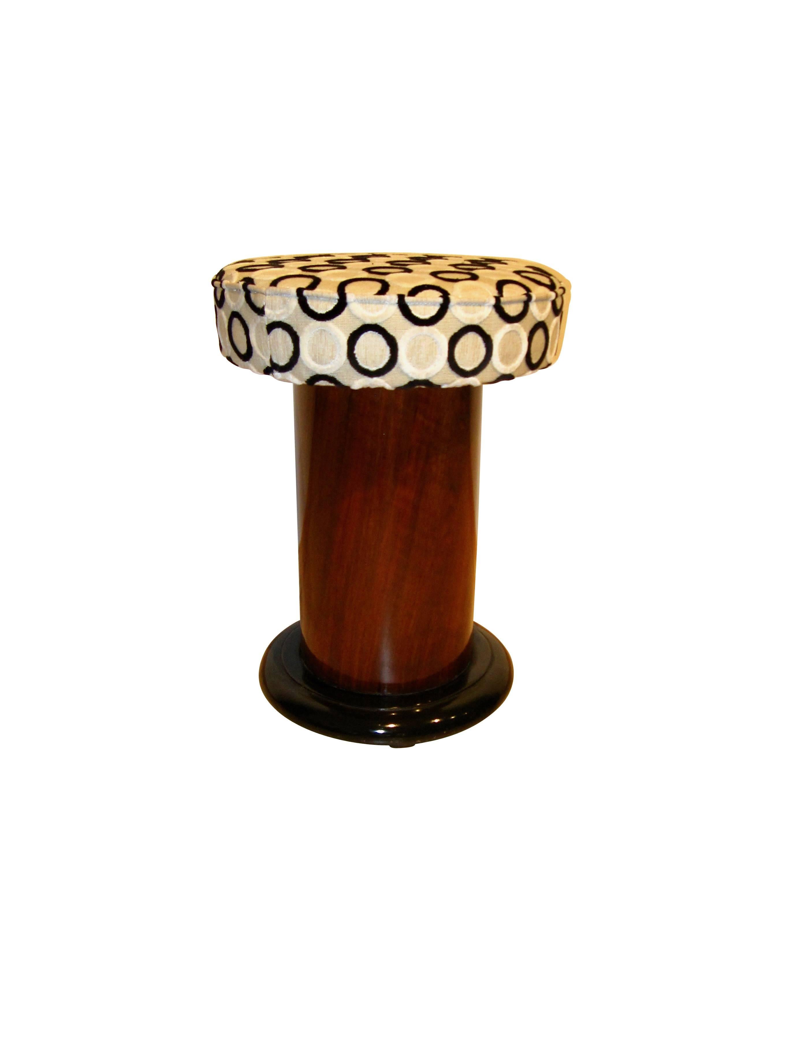 Petite, round Art Deco Stool / Pouff made from Walnut Veneer and ebonized wood for the leg. 

All wooden parts are restored and hand-polished with shellac.
The upholstery fabric is 