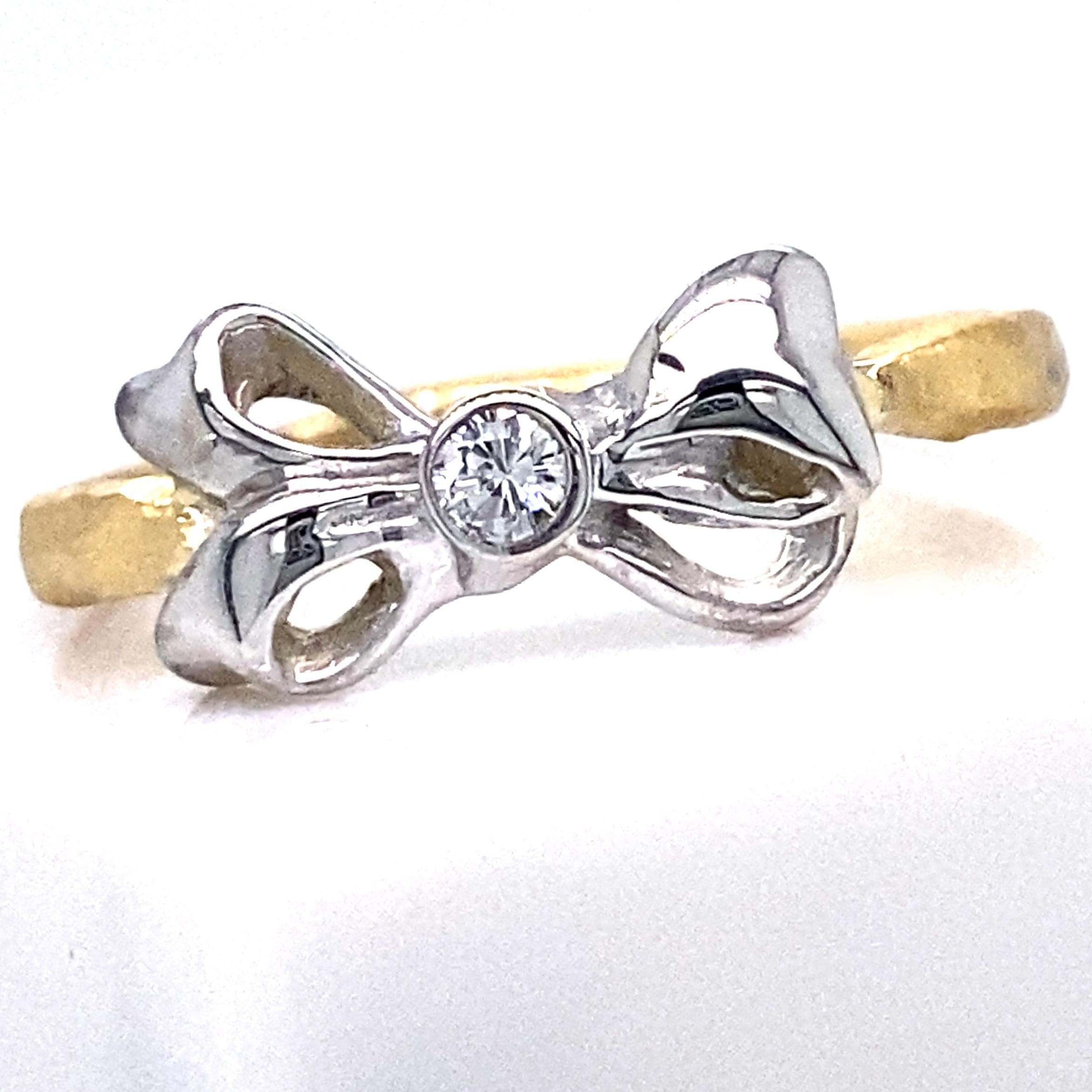 Eytan Brandes has been making this adorable little ring for years, in various combinations of precious metals, with or without diamonds in the center.

This particular ring has a hammered 18 karat yellow gold band with a shimmery satin finish.  The