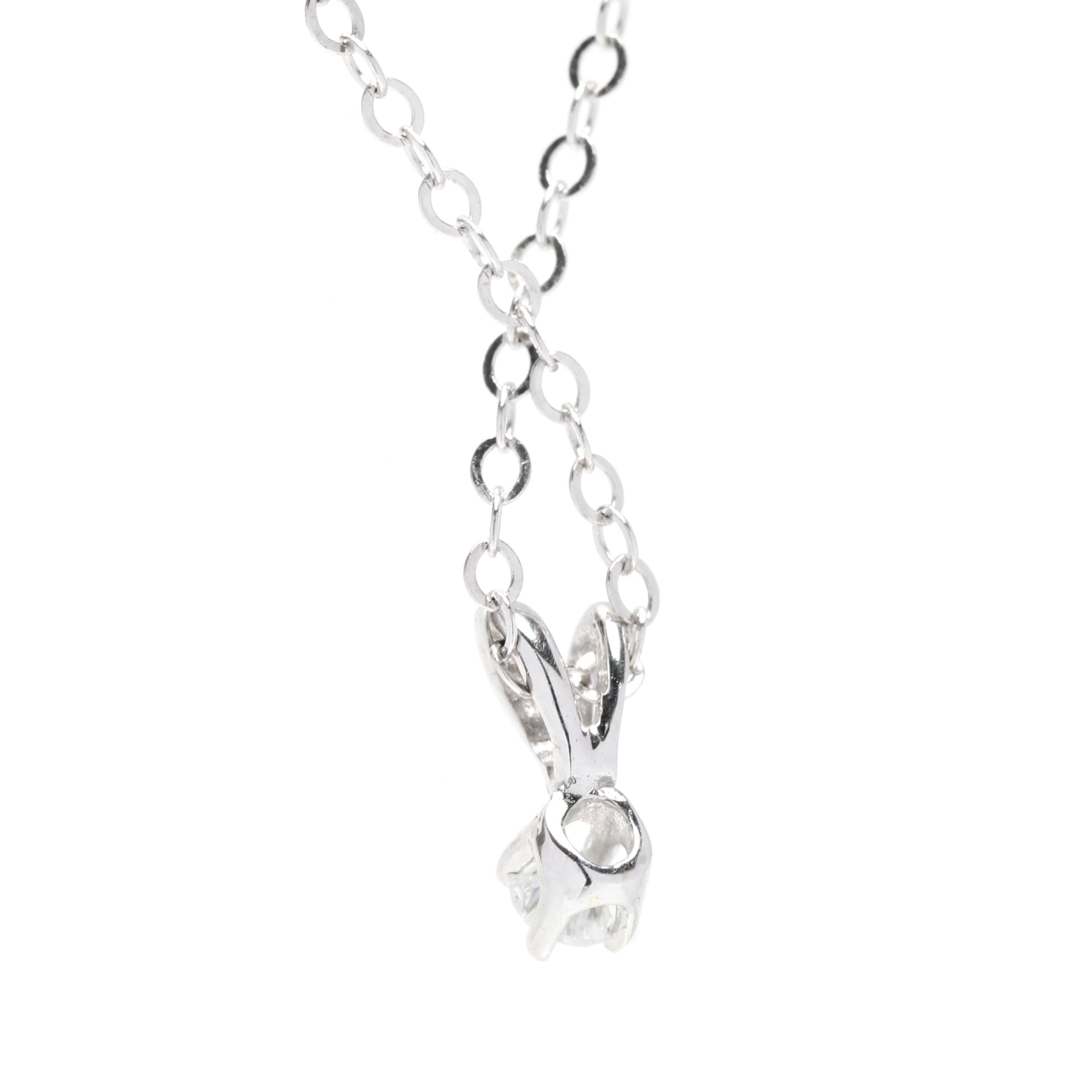This 0.05ctw tiny diamond solitaire pendant necklace is the perfect way to add a bit of sparkle to your everyday look. Crafted in 14K white gold, this delicate necklace features a petite round diamond that is suspended from an 18-inch chain. It's