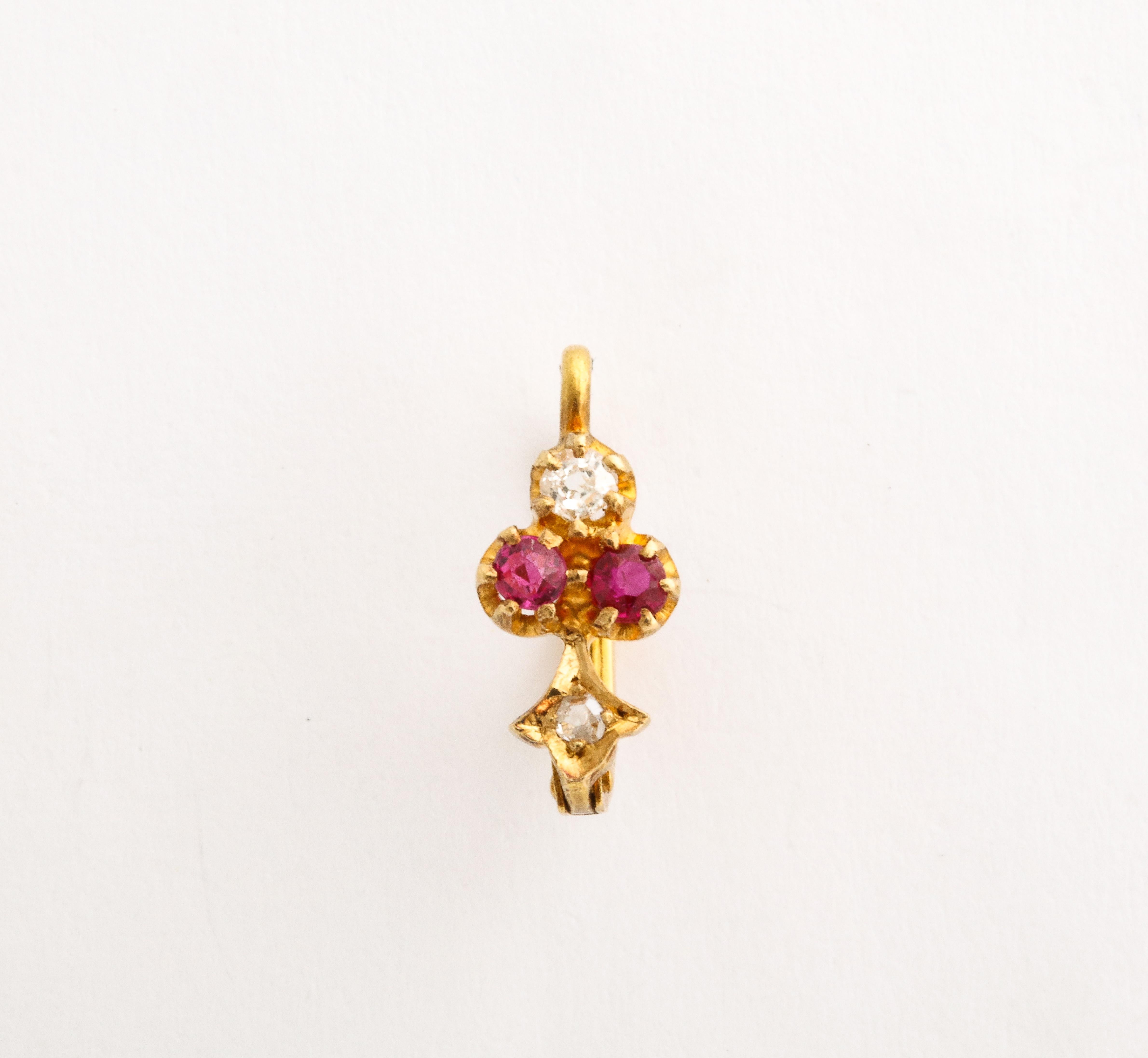 Irresistible, versatile, tiny and precious makes these Ruby and Diamond Earrings for every man or woman. They are 18kt gold with one single cut and one Old Mine Cut diamond and two rose cut diamonds. Four round rubies are central. Earrings are worn
