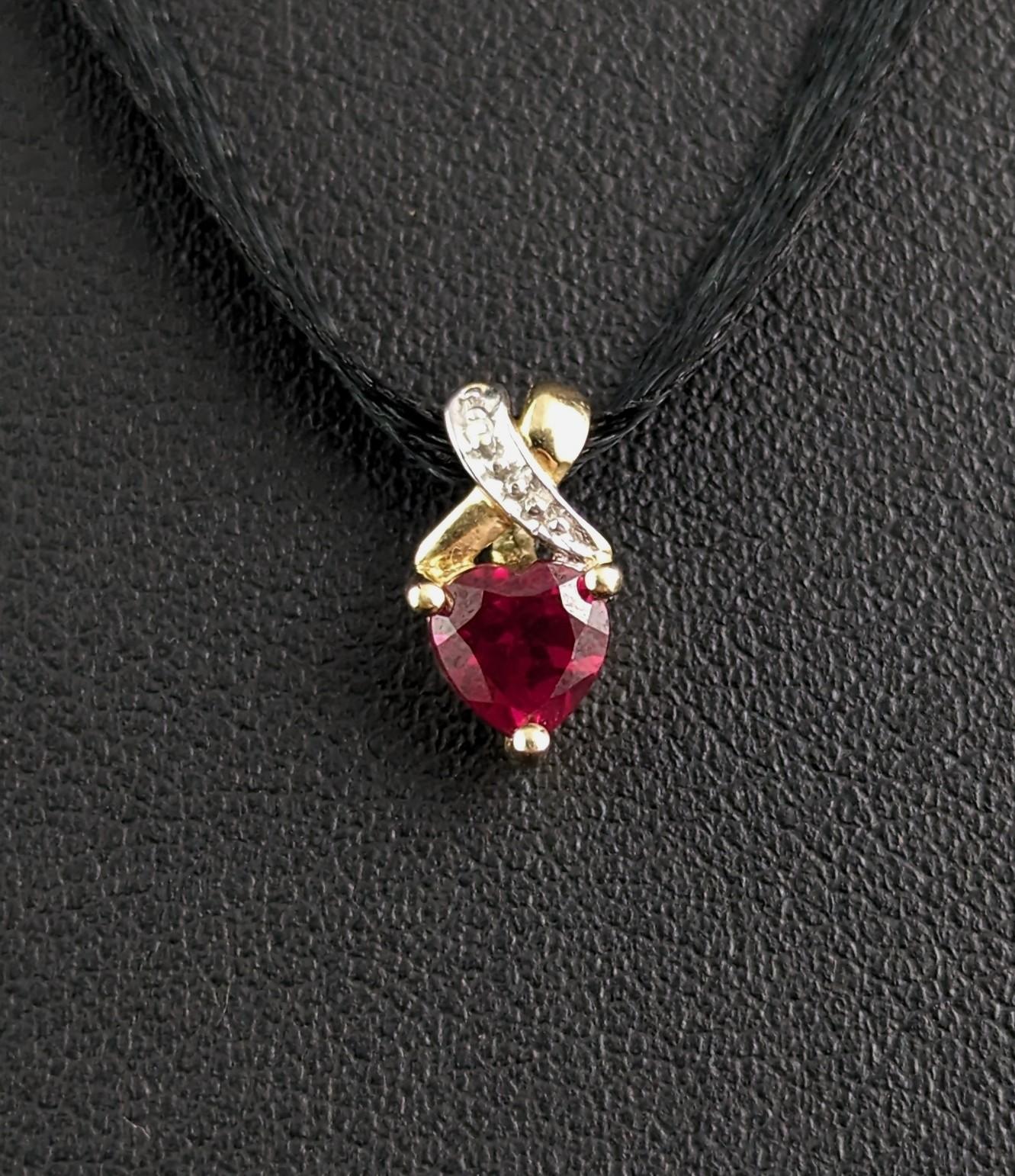 The sweetest teeny tiny, vintage Synthetic Ruby and Diamond heart shaped pendant in 9ct yellow gold.

The ruby has a deep red pink hue and is cut in a heart shape, above the Ruby is a scroll of white gold set with tiny diamond chips.

All set into