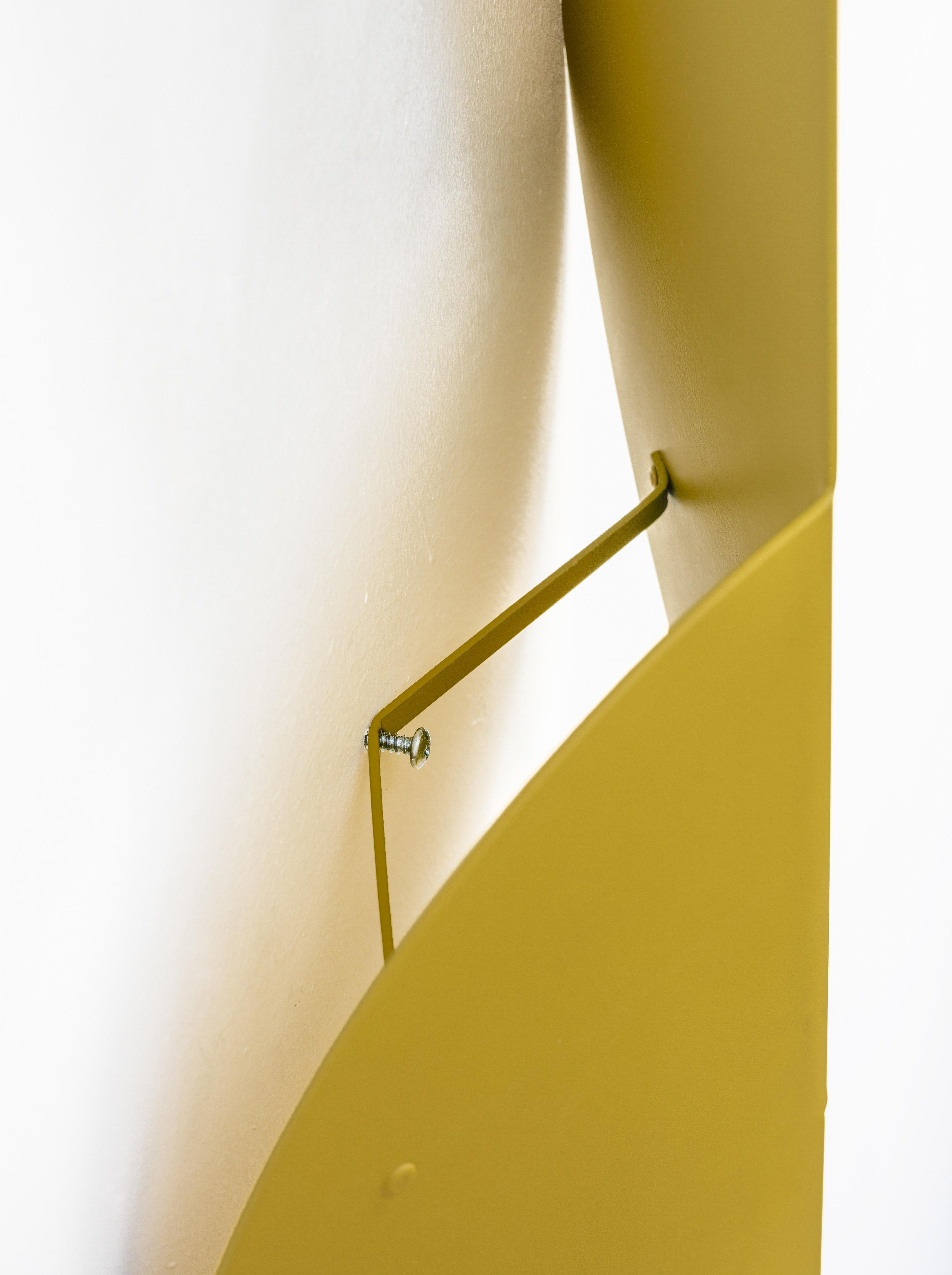 The tip-top wall hanging in mustard is a modern exploration of shape, fold, and color inspired by Bauhaus design principles of simplicity, geometrical form, and primary colors. It can be displayed solo or with other pieces in the Fold Collection.
