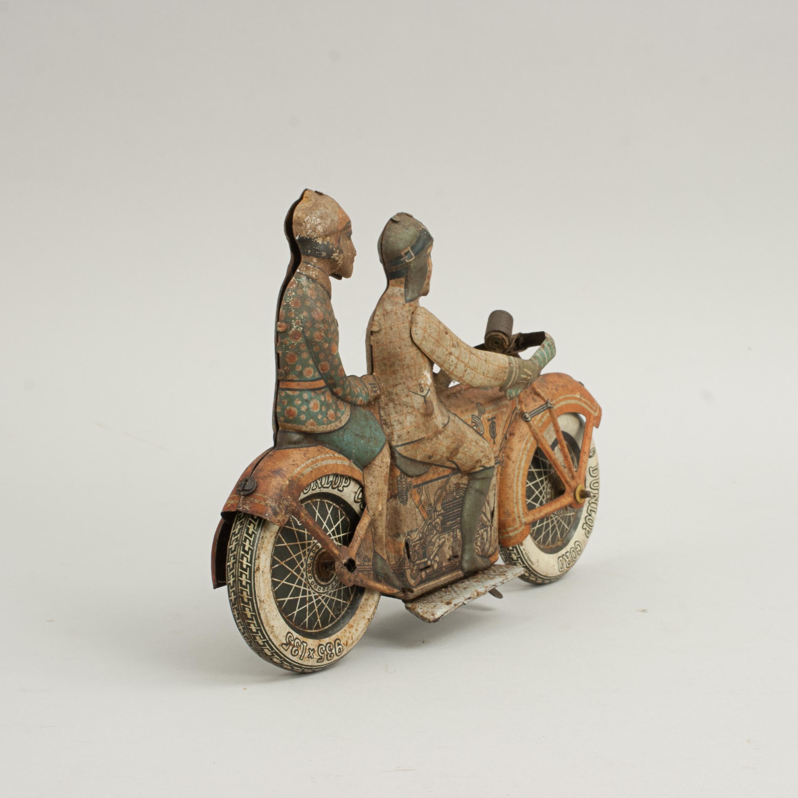 Tipp & Co. Toy Clockwork Tinplate Motorcycle.
A rare, desirable, tinplate wind-up motorcycle by the renowned German manufacturer, Tipp & Co or TippCo. The original tin windup motorbike with a civilian male rider and female pillion passenger. The