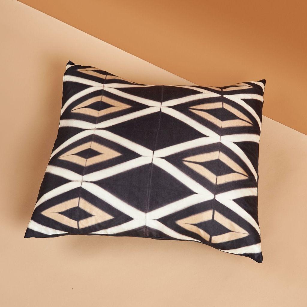 Tisa Black Silk Pillow is luxurious and exquisite with its unique geometric shibori print, which is handcrafted carefully to form symmetrical pattern. As this pillow is 100% handmade from start to finish, each piece is unique. In this pillow we have