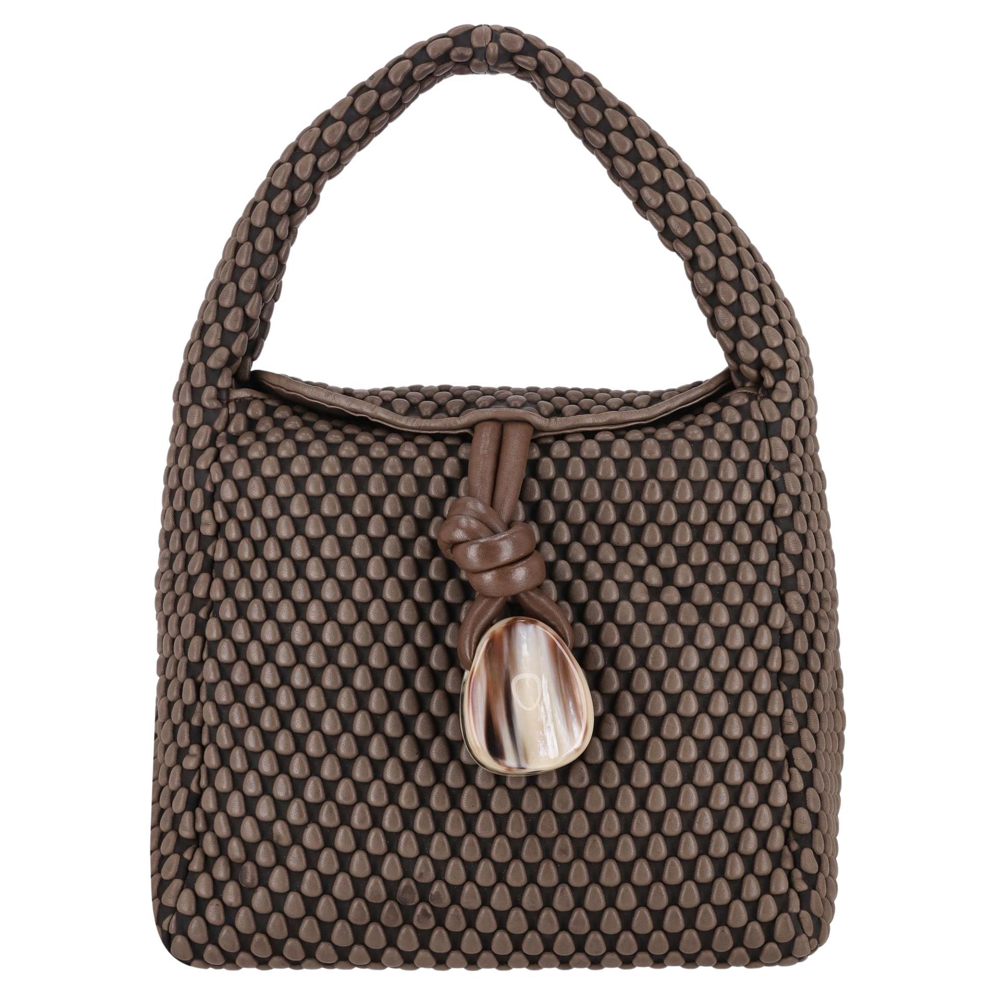 Tissa Fontaneda Uptown Sack Bag With Horn Tassel Adornment To The Front (Sac à dos Uptown avec ornementation de glands en corne sur le devant)