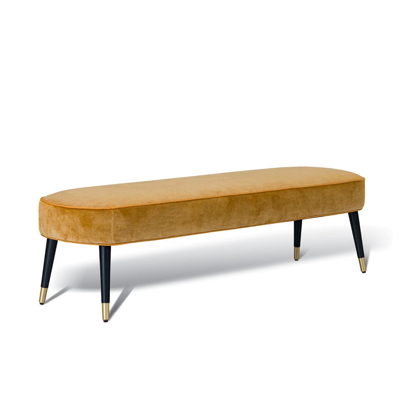 This bench features a lacquered beechwood or walnut wood structure. The legs tip are made of bronze painted metal or satin brass. The plywood seat is padded with high resistance polyurethane foam at variable density. The cover features a grosgrain