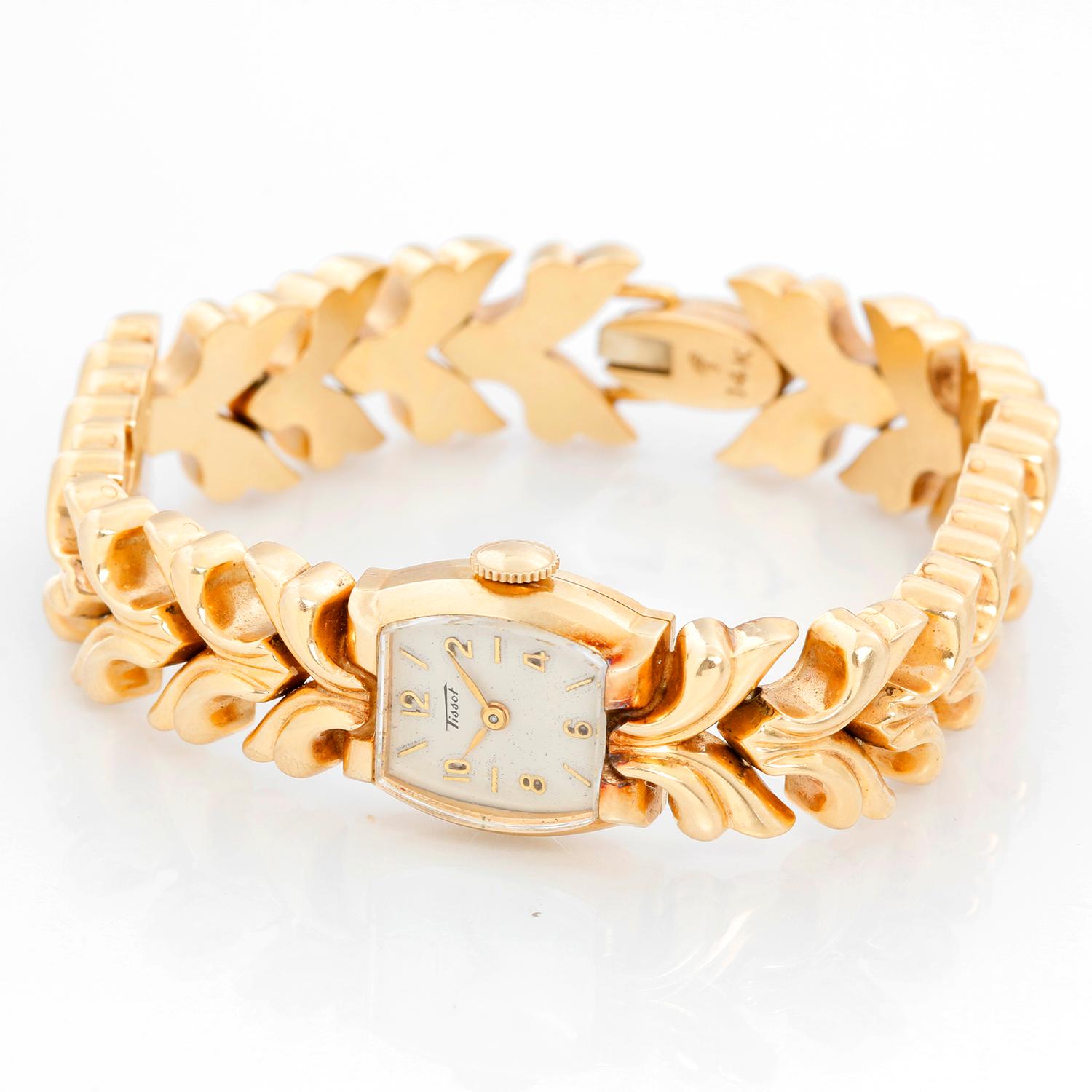 Tissot 14k Yellow Gold Manual Ladies Watch - Manual winding. 14K Yellow gold (16 x 7mm). White dial with stick and Arabic hour markers. 14K Yellow gold link bracelet with hinge clasp; will fit a 6 inch wrist. Pre-owned with Tissot box.