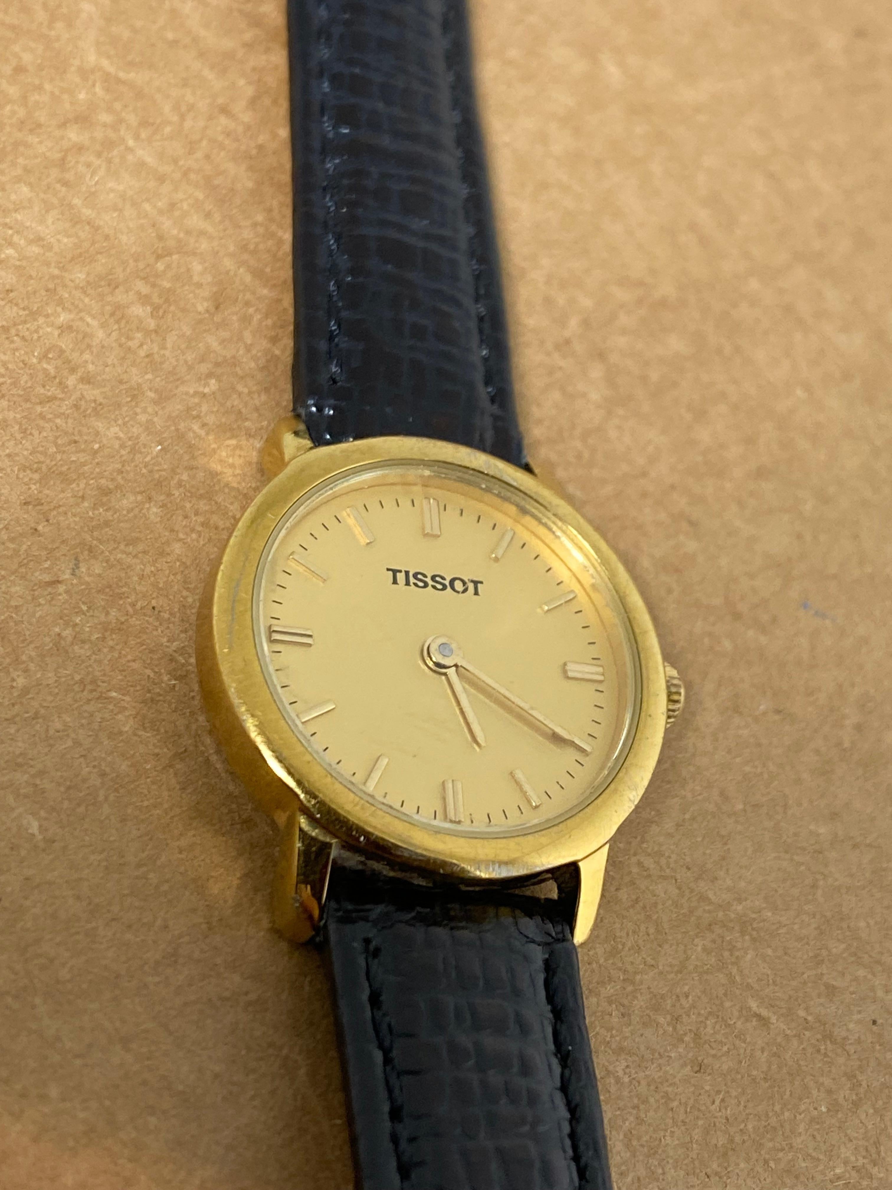 Fine & Elegant ladies' timepiece by Tissot 

featuring a round Case, 
measuring 23mm in diameter
signed & numbered at the back, 

A striking champagne Dial, 
adorned with golden Baton numerals & hands

Powered by Swiss Quartz movement 
(with new