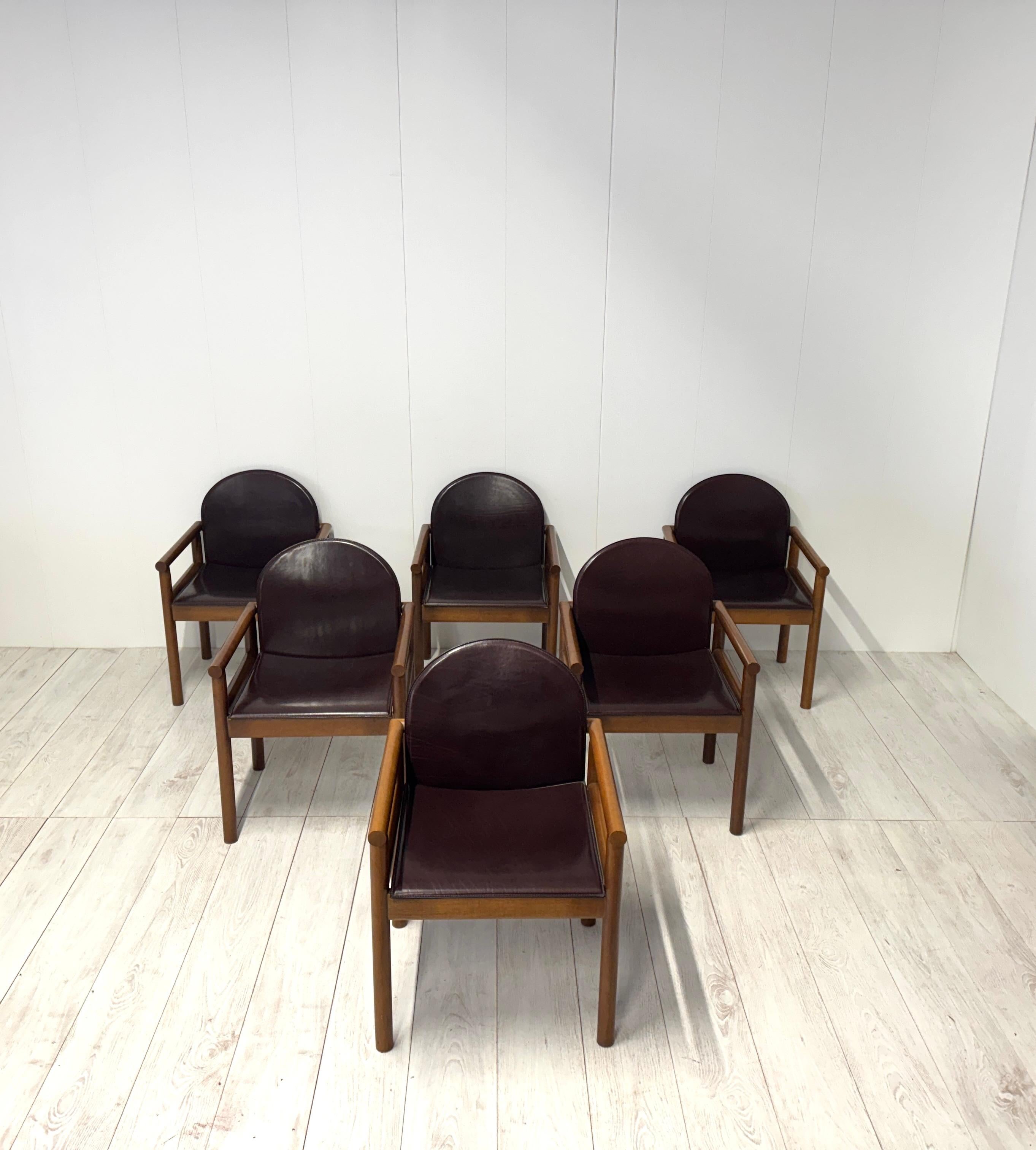 Set of six chairs with arms designed by Titina Ammannati and Giampiero Vitelli, manufactured by catalano, 1970s

The solid wood frame is embellished with seat and back covered in dark brown leather.

Good condition, showing no structural damage.