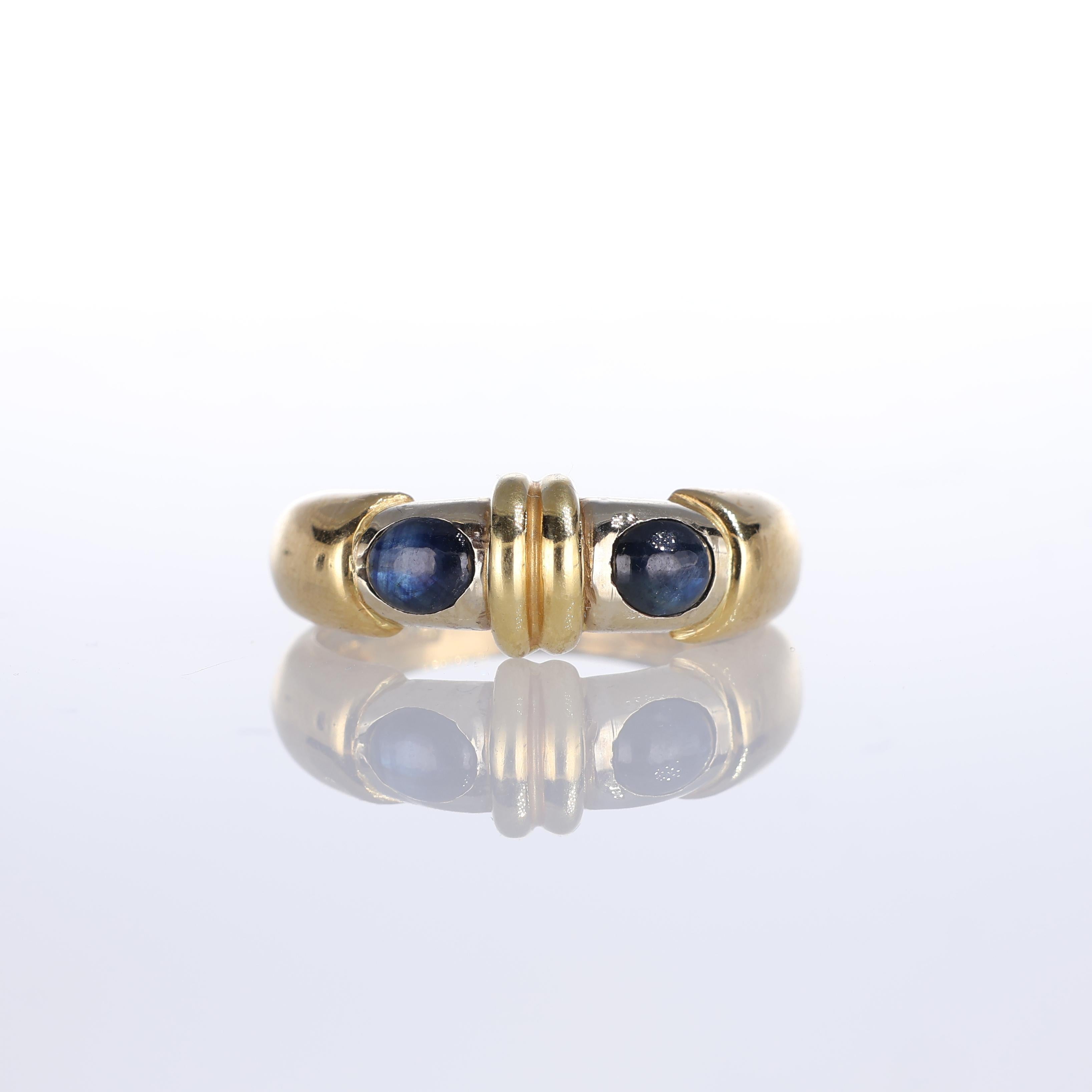 IMPORTANT NOTE:
✔ No additional costs will be added to this order.
✔ Shipping and customs duties are fully covered by us.
--------------------
A refined 18k yellow gold band ring featuring two striking cabochon-cut blue sapphires. The minimal yet