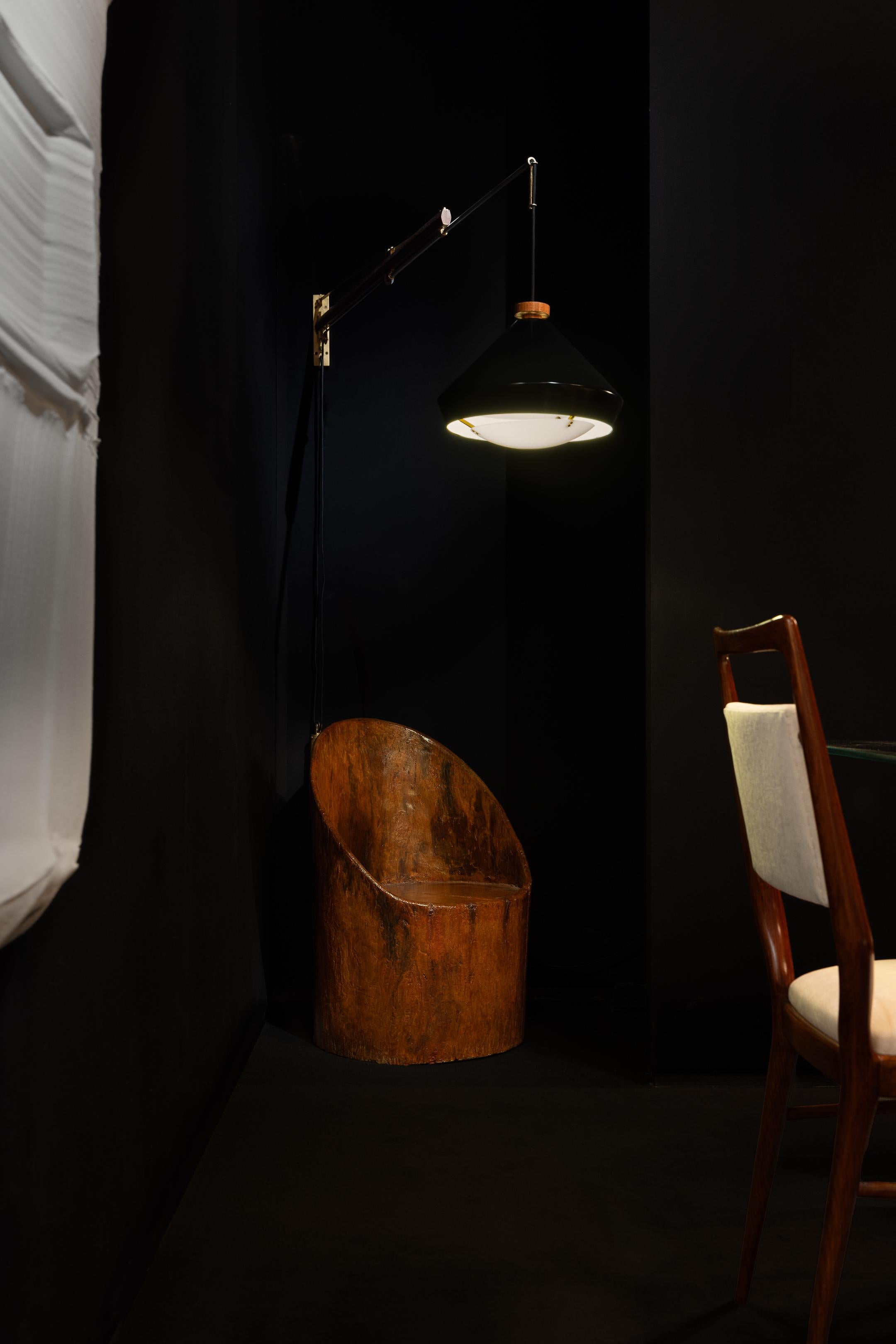 Rare adjustable 177a wall lamp designed by Tito Agnoli and manufactured by Oluce in Italy in 1957. This lamp is made with a beautiful blended use of materials. The lamp has a brass wall plate that includes the light switch and cable output. On the