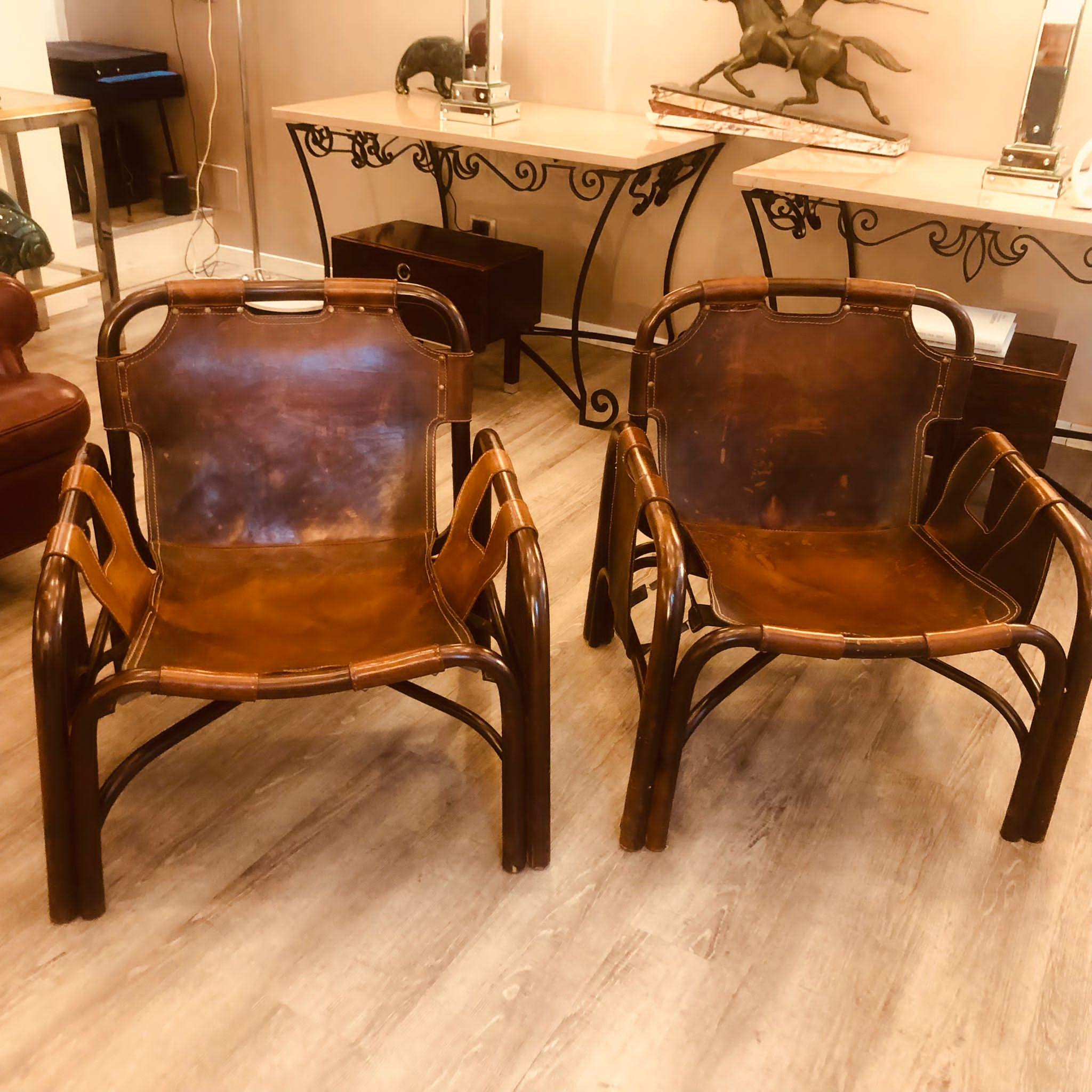 Tito Agnoli 1960s bamboo and brown leather armchairs, set of 2 
Good conditions. No structural damages and no cuts in the leather. Leather has been treated with cream to hydrate it.
Size: W 68 cm D 70 cm H 72 cm 
For their shape and materials