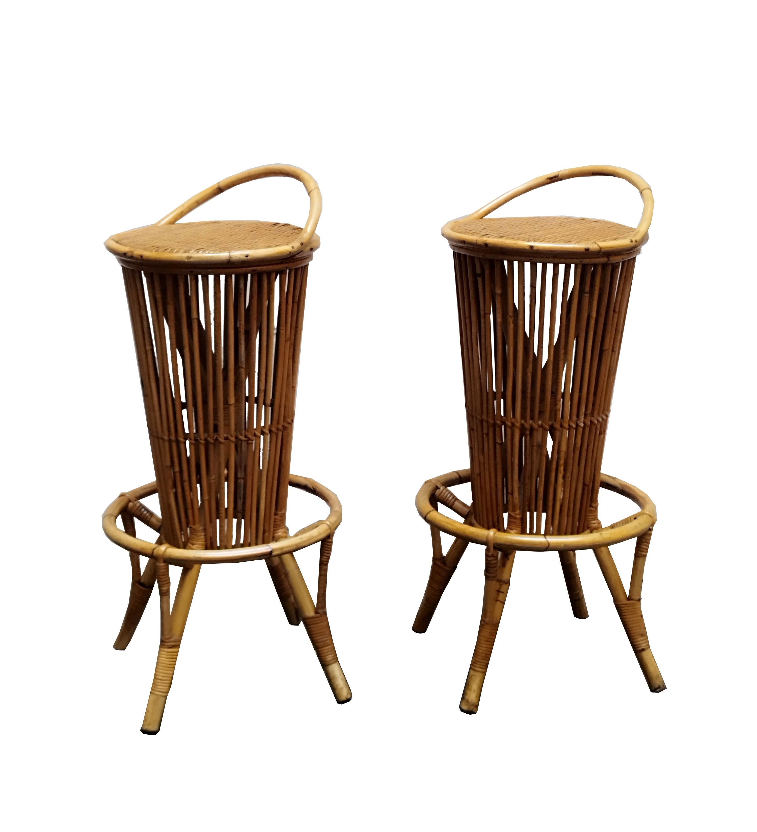 Wonderful pair of stools made of a beautiful mix of bamboo, rattan and wicker. This charming set was designed by Tito Agnoli and made in Italy in the 1960s. Completely original and in spectacular condition.This pair of stools of exceptional quality,