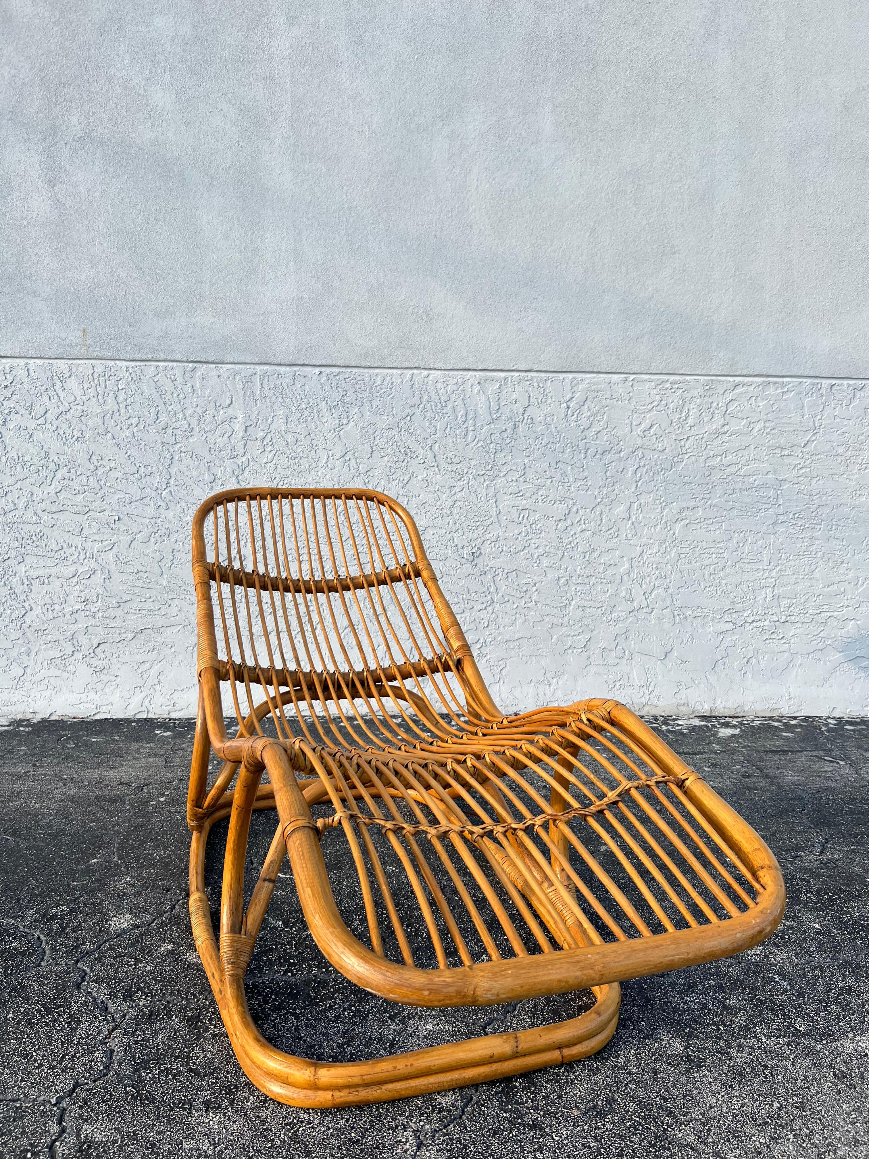 Tito Agnoli attributed rattan chaise lounge. One of a set of 2 that we are currently offering, this one in particular being in a slightly less reclined position. Cane wrapped portions are in tact with some wear to the finish (please refer to