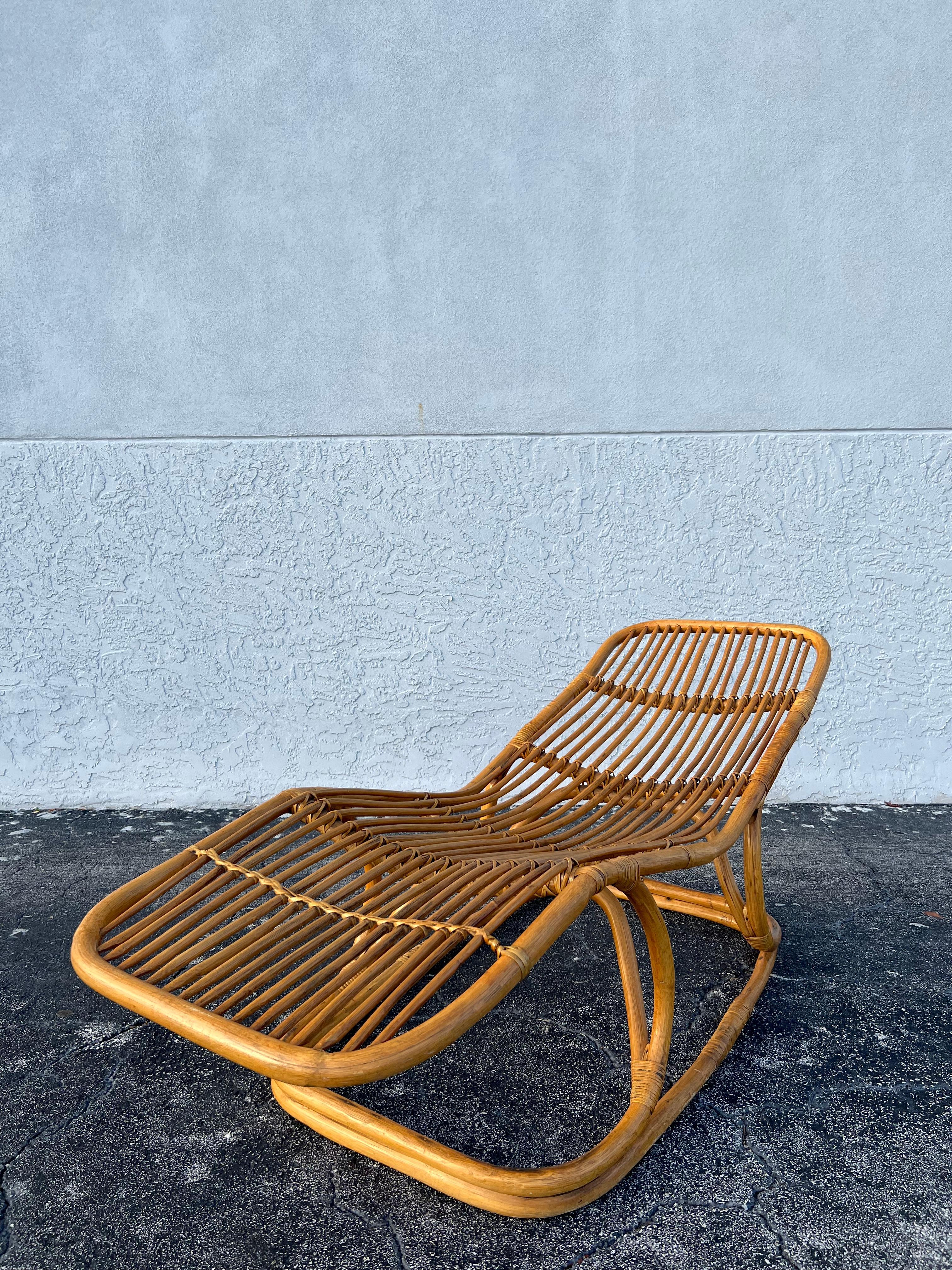 Tito Agnoli attributed rattan chaise lounge. One of a set of 2 that we are currently offering, this one in particular being in a slightly more reclined position. Cane wrapped portions are in tact with some wear to the finish (please refer to