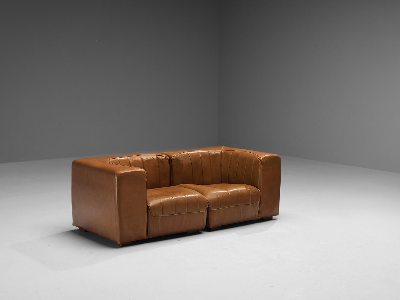 Tito Agnoli for Arflex, two seat sofa, model '9000', patinated leather, wood, Italy, 1969

This design is characterized by a cubic outer frame that provides a visually interesting contrast to the round seat. When seated you experience a pleasant