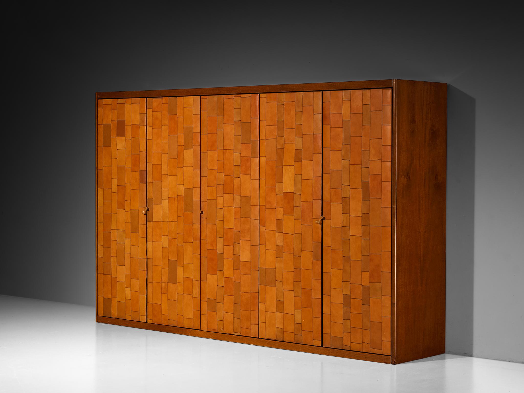 Tito Agnoli for Caleido/Poltrona Frau, wardrobe, patchwork cognac leather, stained birch, metal, Italy, 1970s.

A striking and rare wardrobe designed by Tito Agnoli for Caleido, a subsidiary of Poltrona Frau. Crafted in Italy during the 1970s, this