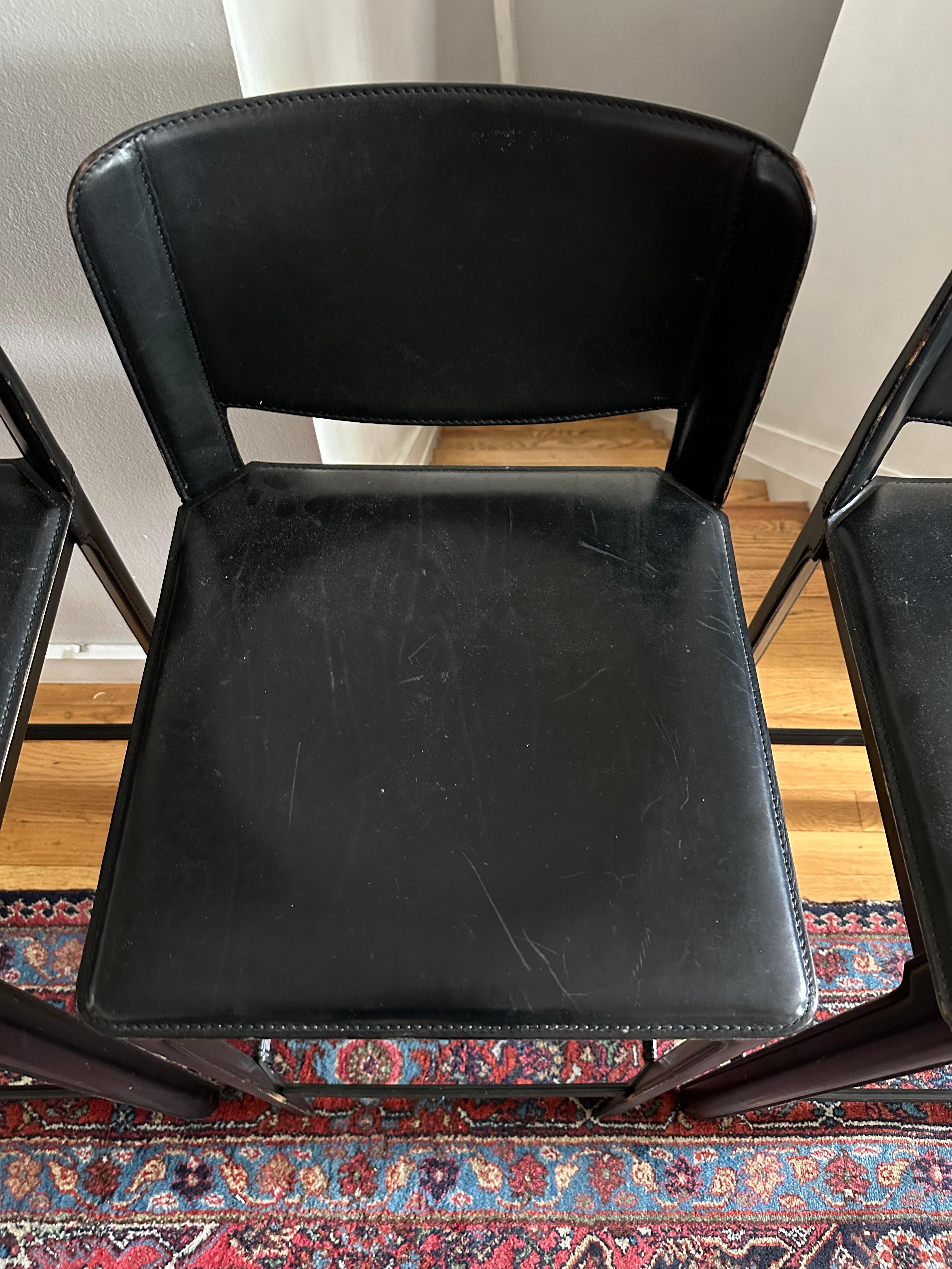 Set of three Matteo Grassi Italian black saddle-stitched leather over metal bar stools, circa 1980s. Priced as a set of three.