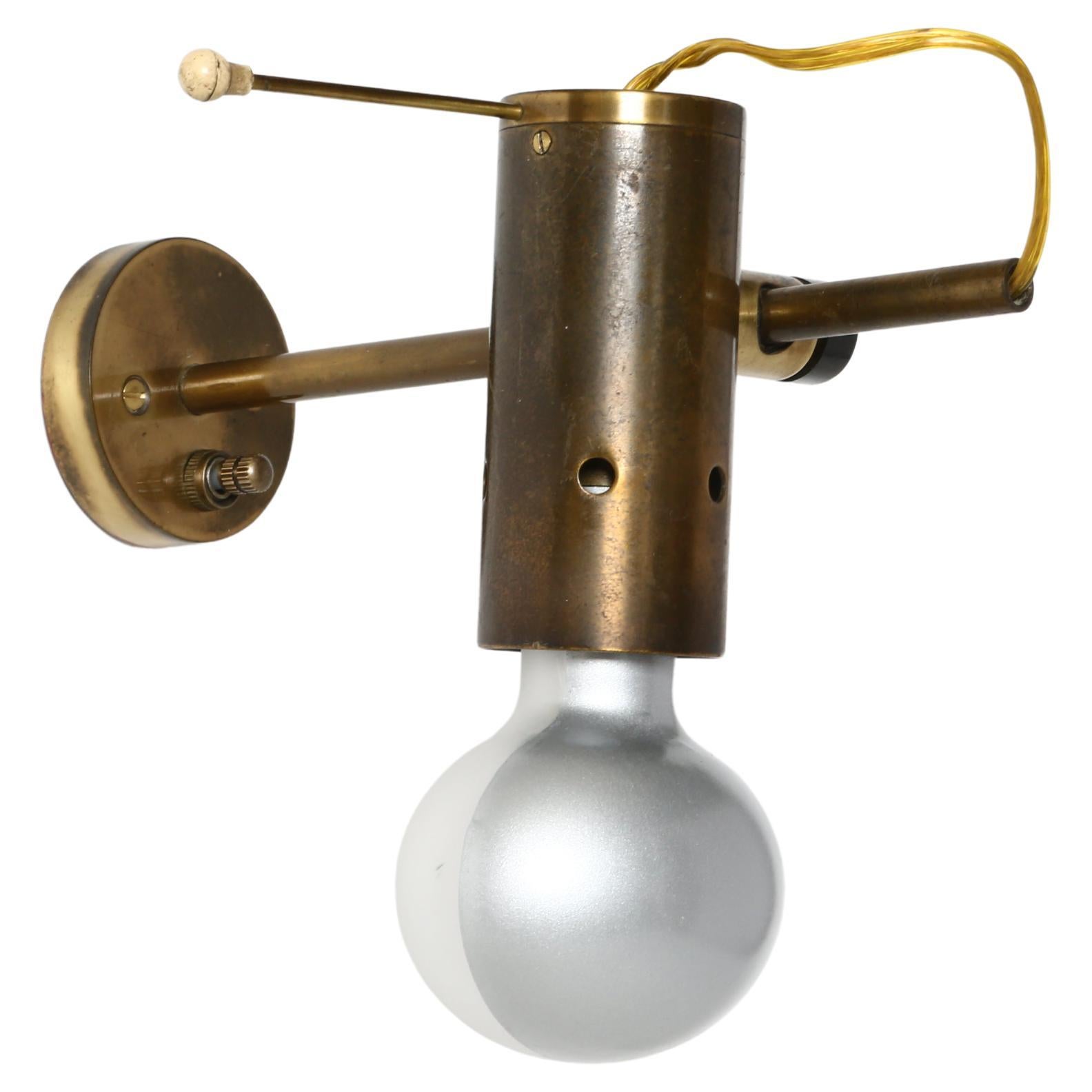 Tito Agnoli for Oluce sconces Model 186, a pair
Designed and made in Italy in 1960s
Patinated brass. 
Full 360 degrees rotation of the bulb.
Sconces have a special Oluce designed light bulb.
B22 socket on the entrance and G9 inside.
Complimentary US