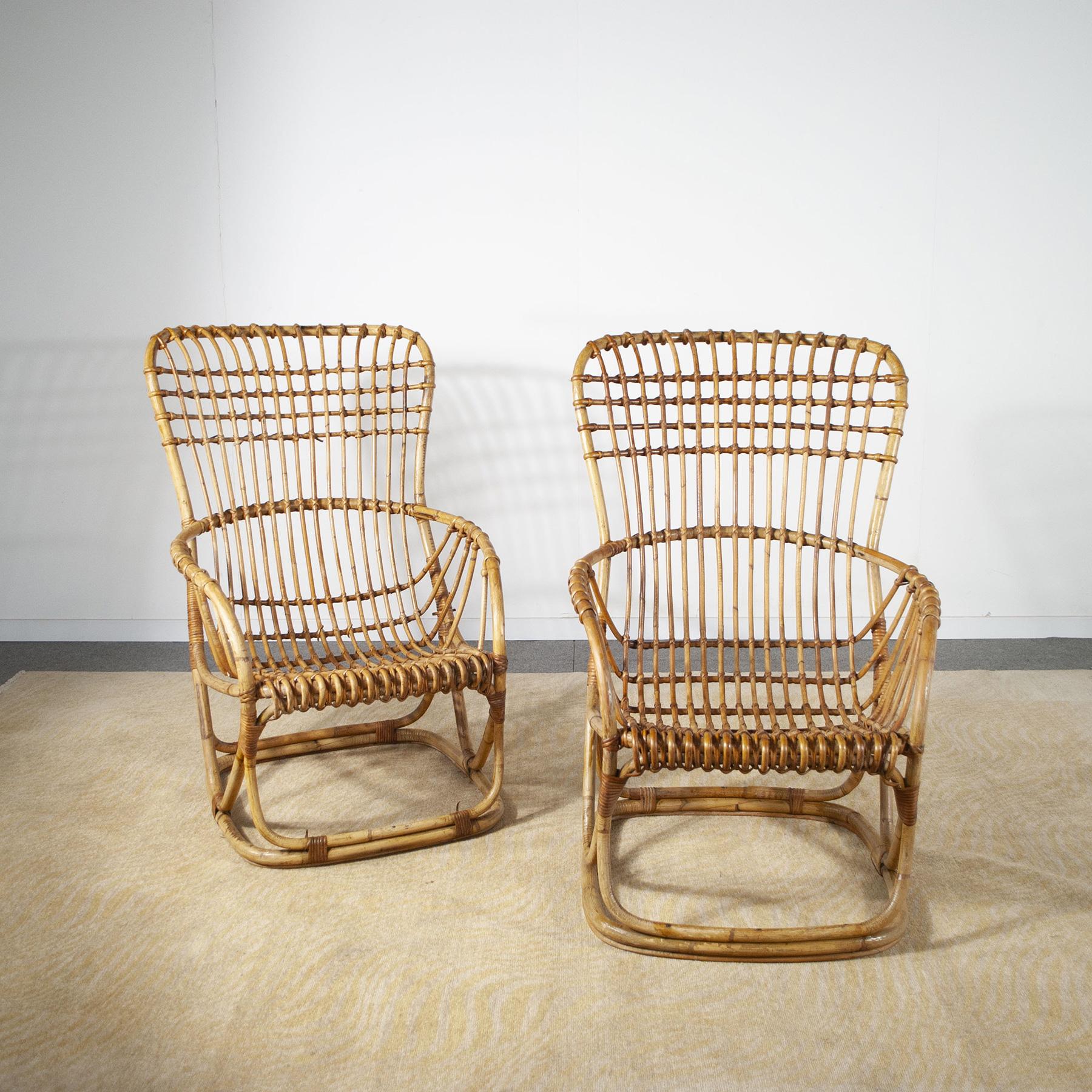 A set of two armchairs in the style of Tito Agnoli for Bonacin in bamboo and cane.