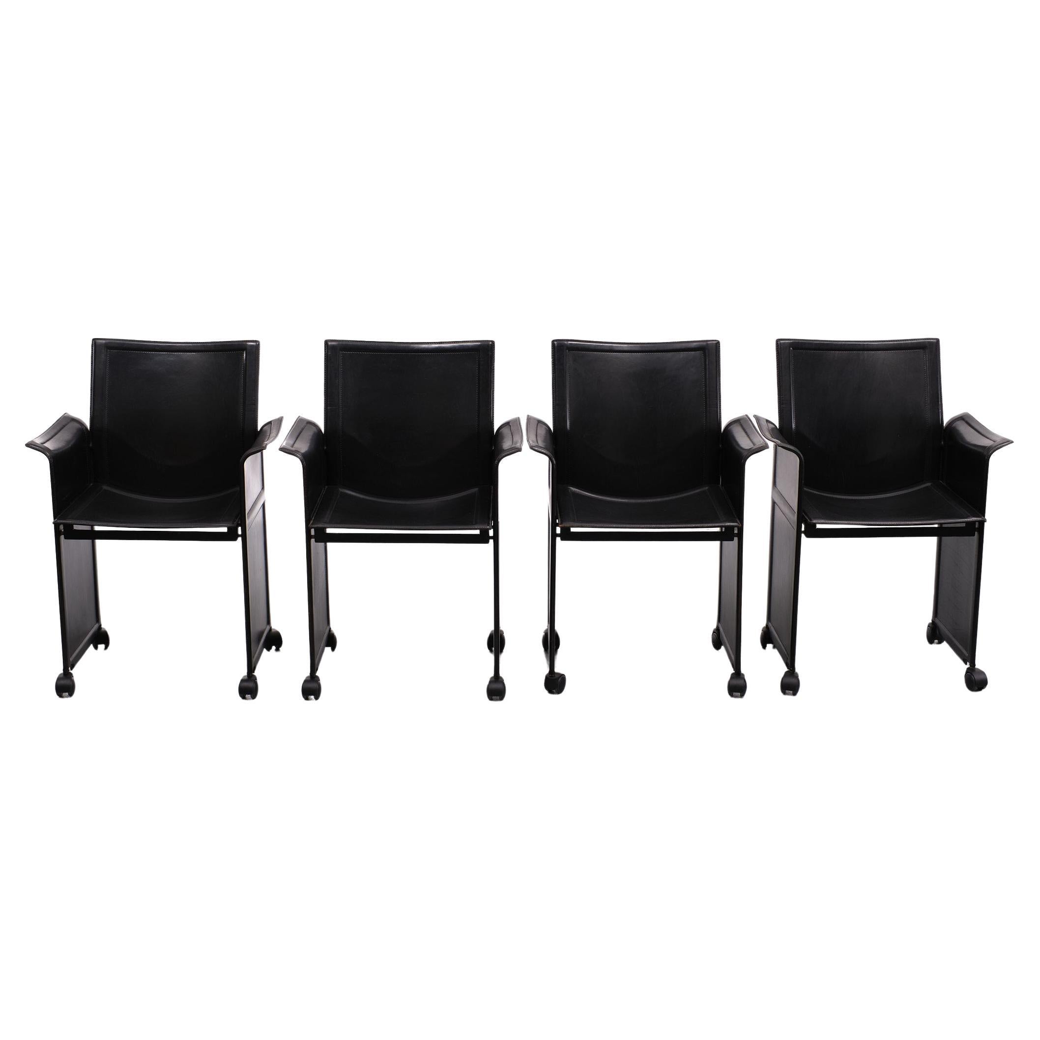 Set of 4 of black Korium armchairs on wheels designed by Tito Agnoli for Matteo Grassi in 1978. All new wheels. Signed. Steel frame complete covered with thick black leather. Great seating comfort. 

Tito Agnoli was an assistant to Gio Ponti at