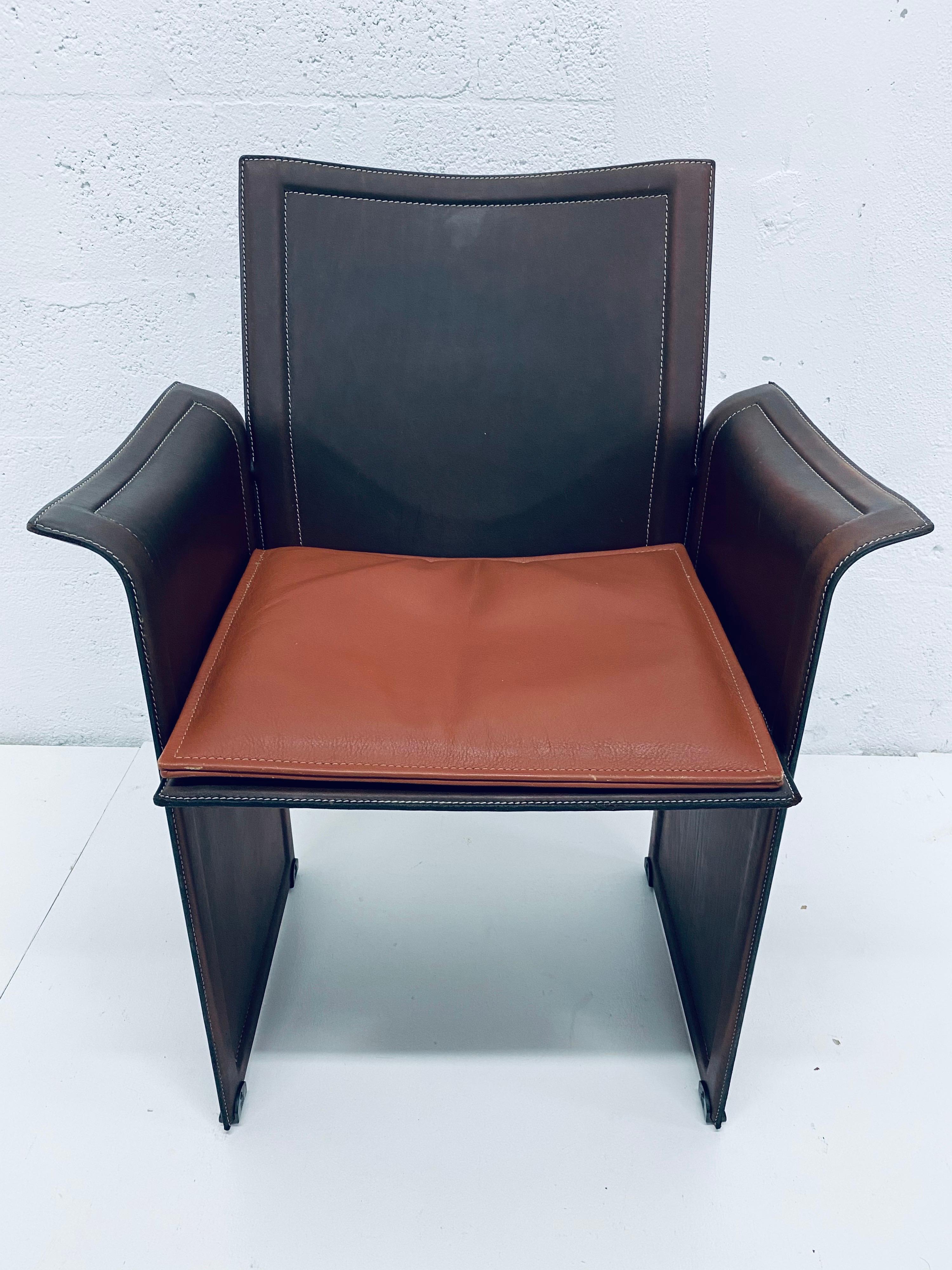 Single patinated brown leather Korium chair by Tito Agnoli for Matteo Grassi. The arms have a wing like appearance and the seat comes with an extra cushion for added comfort. Perfect for the desk or as an occasional side chair.