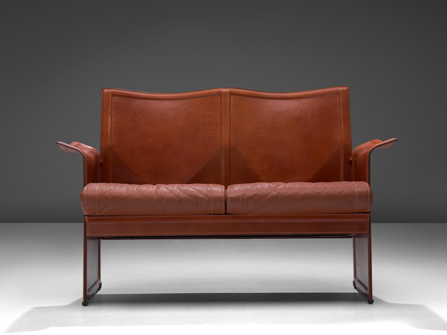 Tito Agnoli for Matteo Grassi, Korium sofa, leather and metal, Italy, 1970s

This sophisticated iconic Korium cognac leather sofa were designed by Tito Agnoli for Matteo Grassi. It features a strong structure, with a wing like appearance and