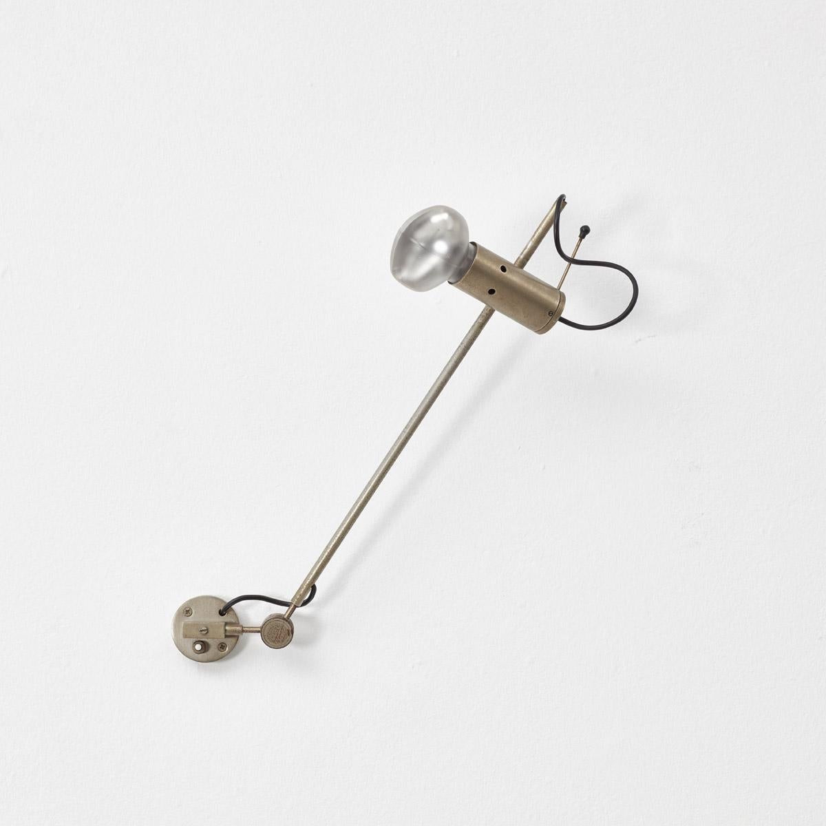 The Model 194 wall lamp is a rare piece by Tito Agnoli for Oluce, Italy 1954. This in an early edition, featuring nickel-plated steel arms and hardware, with an original Cornalux ‘hammerhead’ light bulb. This design is distinctive for its