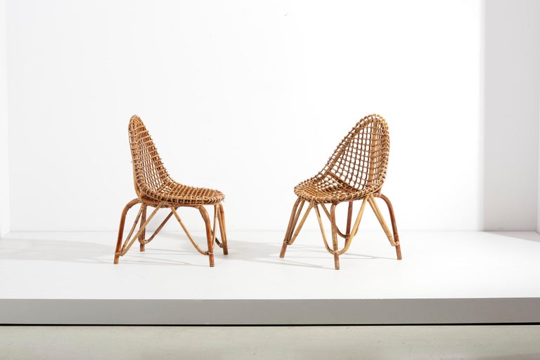 Tito Agnoli pair of chairs in Rattan, Italy - 1950s. We have also listed a Tito Agnoli mirror and an umbrella stand in the same style.