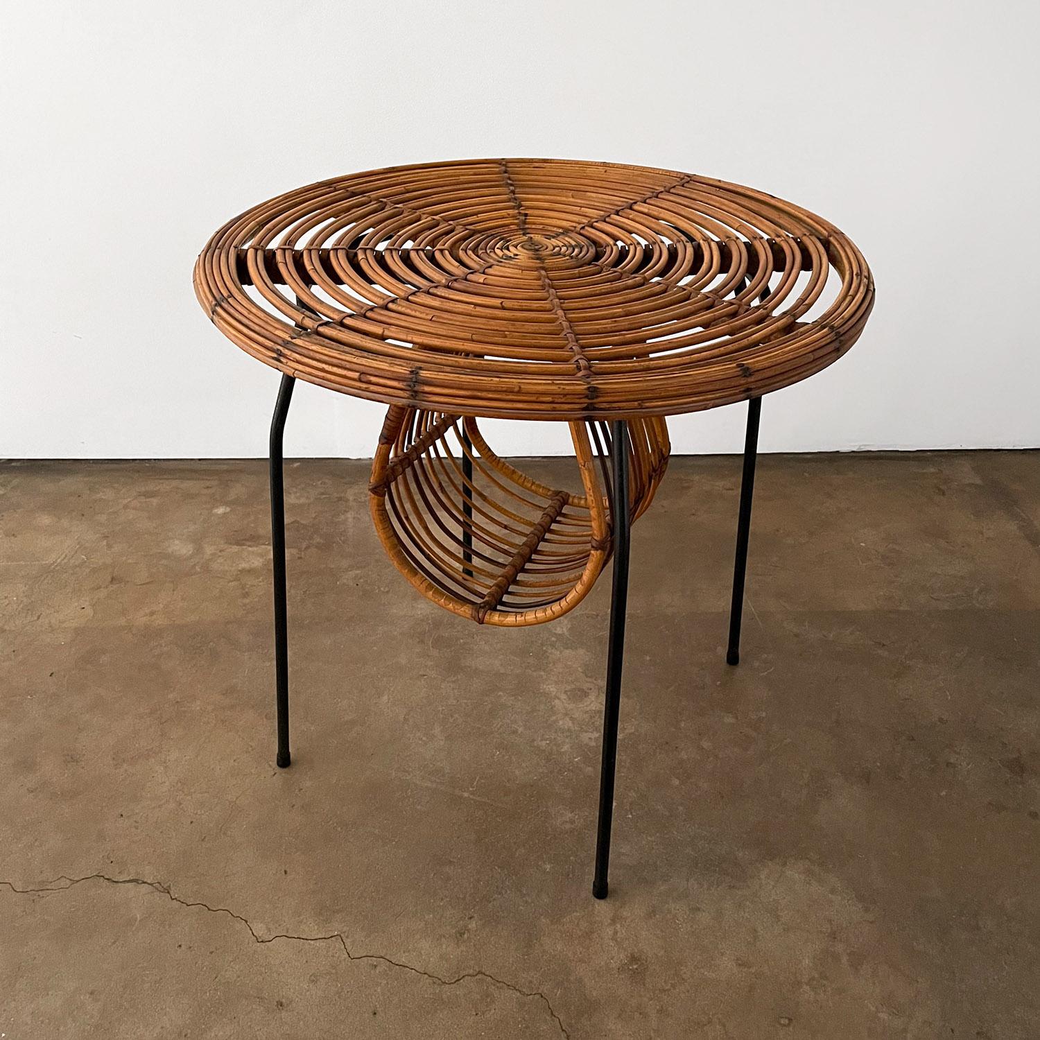 Tito Agnoli for Bonacina
Italy, circa 1970's
Sculpted rattan side table with a newspaper / magazine holder 
Tubular steel legs
Concentric rings with nailhead rivet detail
Lovely patina.
   