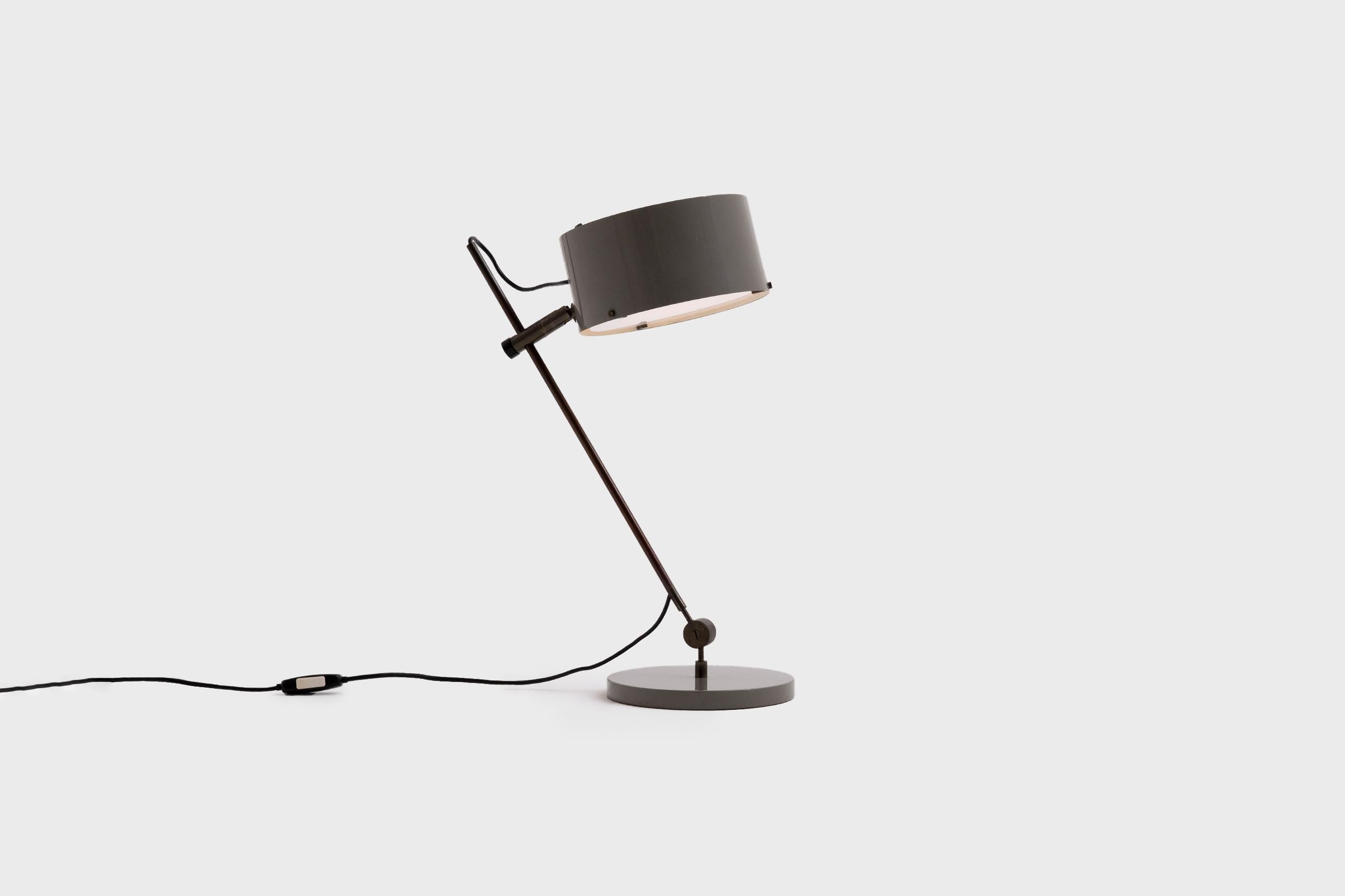 Rare table / desk lamp by Tito Agnoli for Oluce, Italy, circa 1955. Exceptional refined design and use of materials; burnished brass, enamelled aluminum and opal glass. The lamp can be place in different positions dus to the joints and adjustment