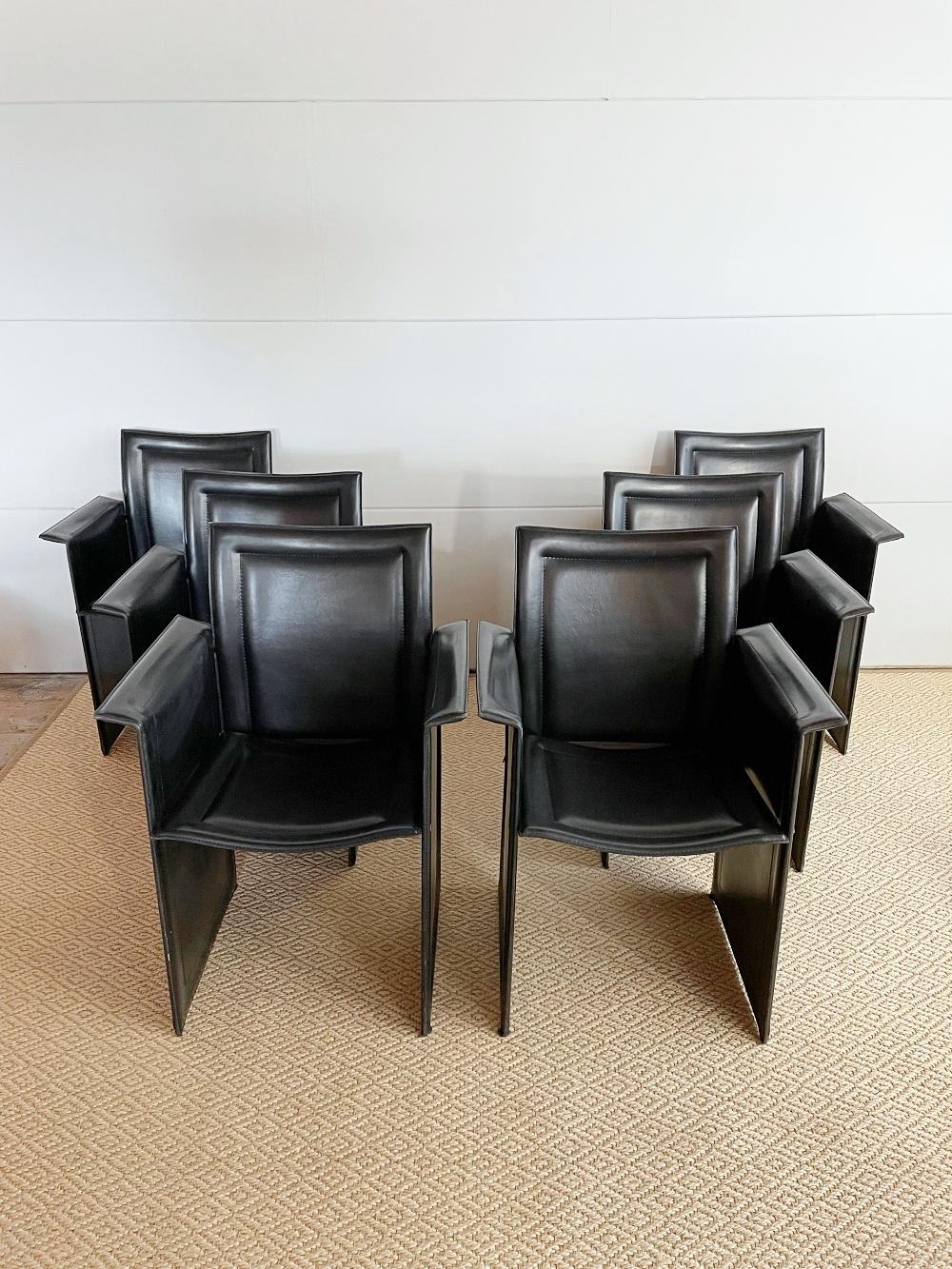 A set of six Postmodern sculptural dining chairs designed by Tito Agnoli and handmade by Calligaris in Italy, 1980s. They feature a metal construction covered with thick black leather. The chairs are very elegant and high comfortable. 

