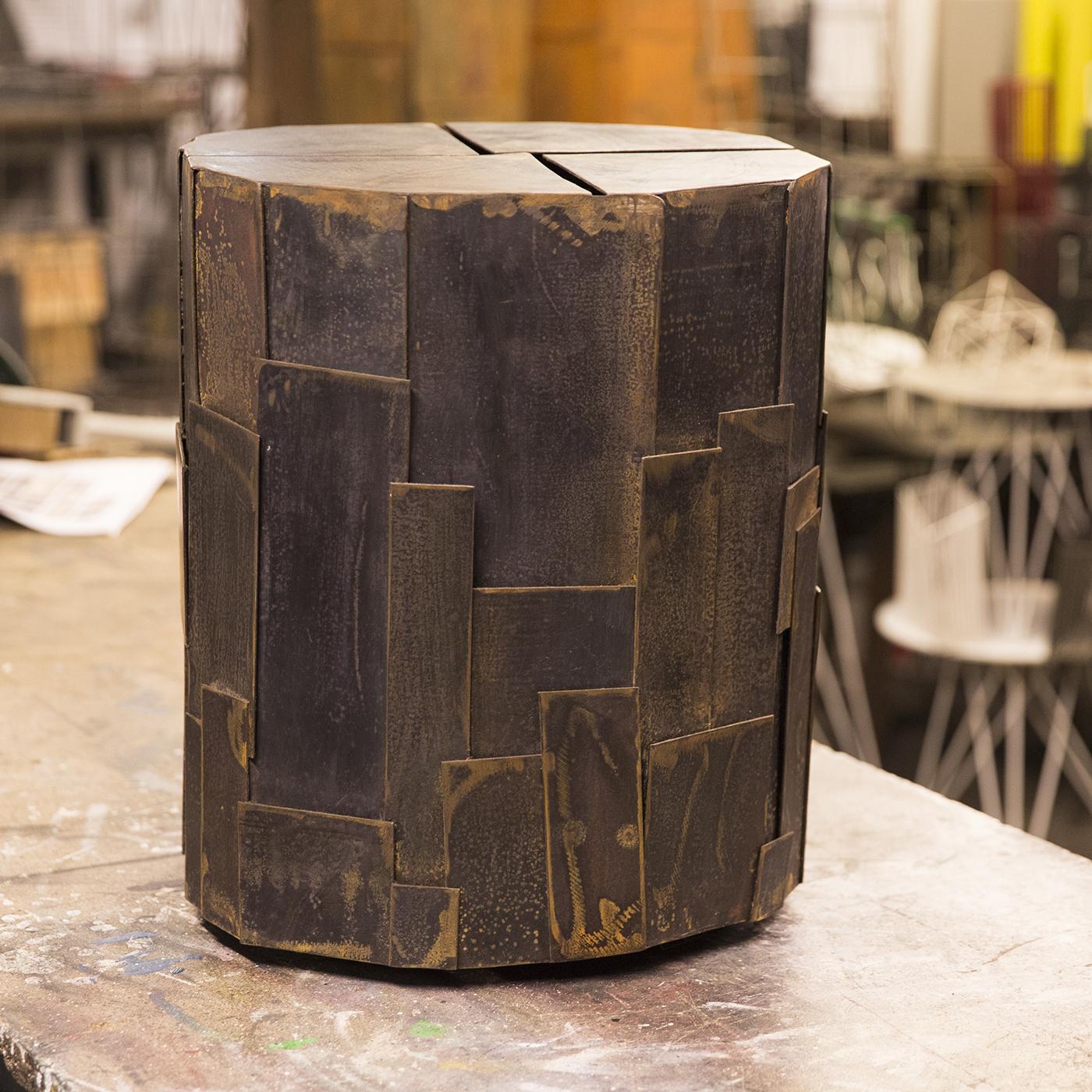 Sculptural side table in treated iron sheet by Sciortino. The metalwork is painted black, with a rough finish that lends the work an air of industrial. Measurements and finish may vary slightly due to the artistic nature of Sciortino's